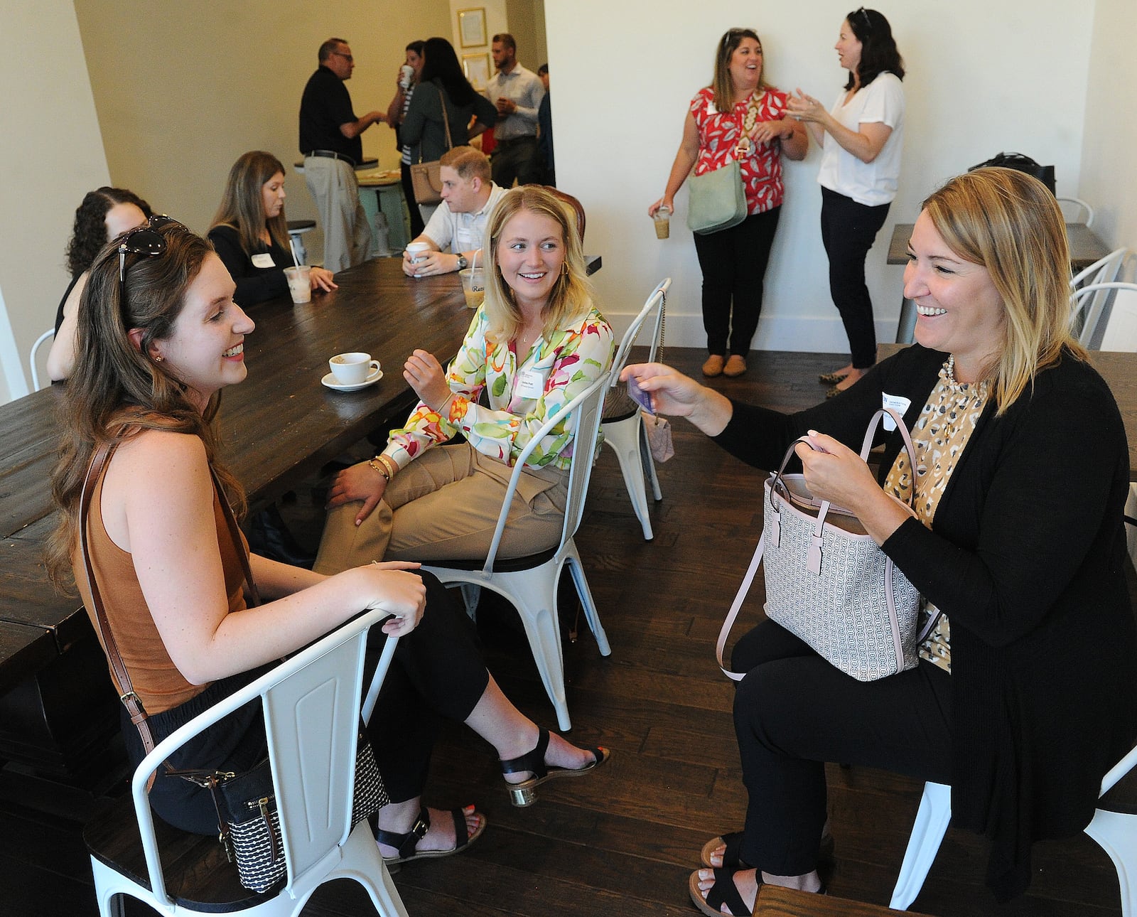 Taking at the mixer for Young Professionals at Reza's Downtown Cafe on Thursday, July 21, 2021, from left, Evelyn Ritzi, Caroline Pratt and Sarah Malchow.  MARSHALL GORBY\STAFF