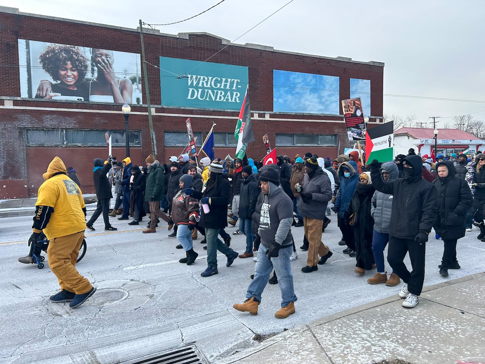 People walk in the 2024 MLK Day march on Dayton's West Side Monday in celebration of civil rights leader Martin Luther King, Jr. Eileen McClory / staff