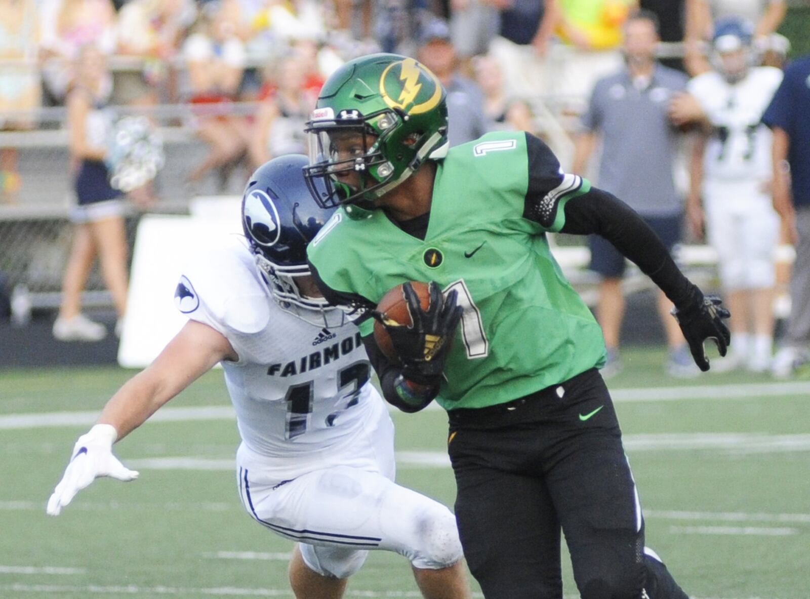 Northmont’s John Golson (with ball) eludes Fairmont’s Andrew Murray and scores on a 55-yard catch and run. Northmont defeated visiting Fairmont 24-21 in a Week 2 high school football game that was suspended on Friday due to weather delays and completed on Saturday, Sept. 1, 2018. MARC PENDLETON / STAFF