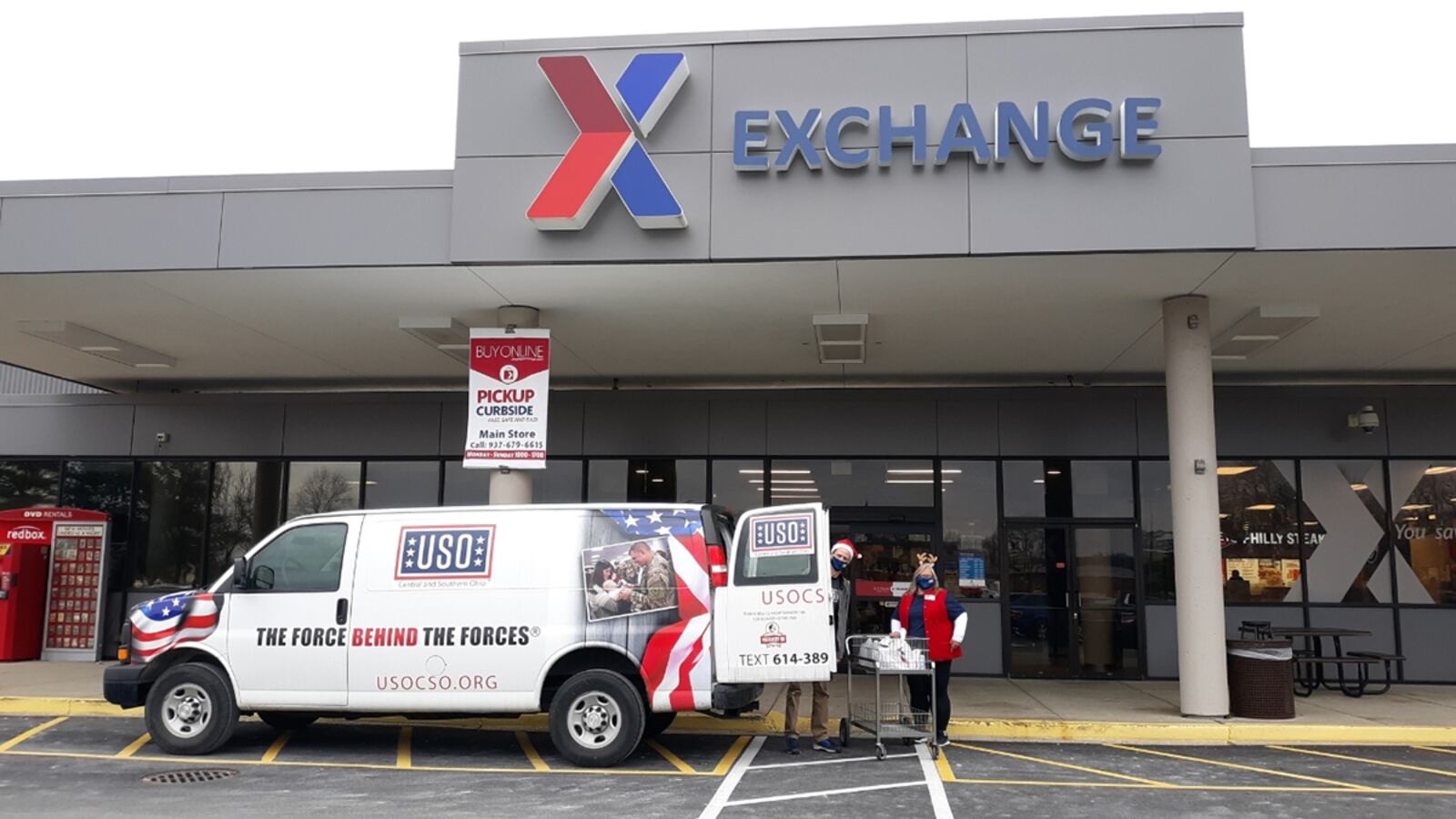 Two USO volunteers load personal shopper program orders at the Wright-Patterson Base Exchange on Dec. 20. The program allows deploying Air Force personnel to place an order while in quarantine to have items and other goods delivered. U.S. AIR FORCE PHOTO/SENIOR AIRMAN EMILY RUPERT