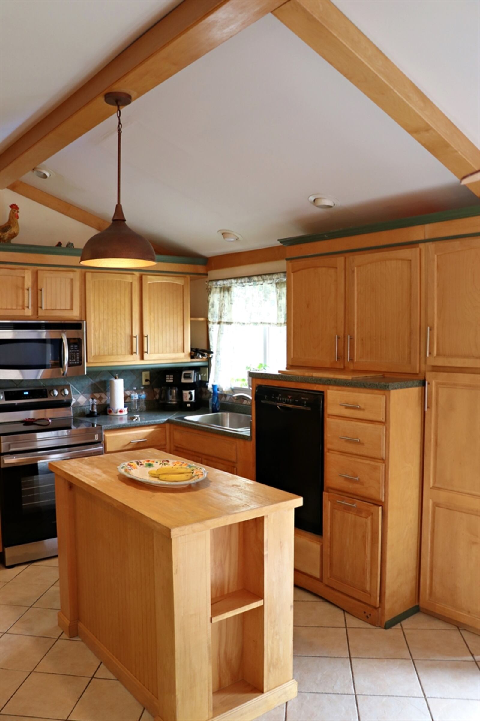 Ceramic-tile flooring fills both the kitchen and the dining area.