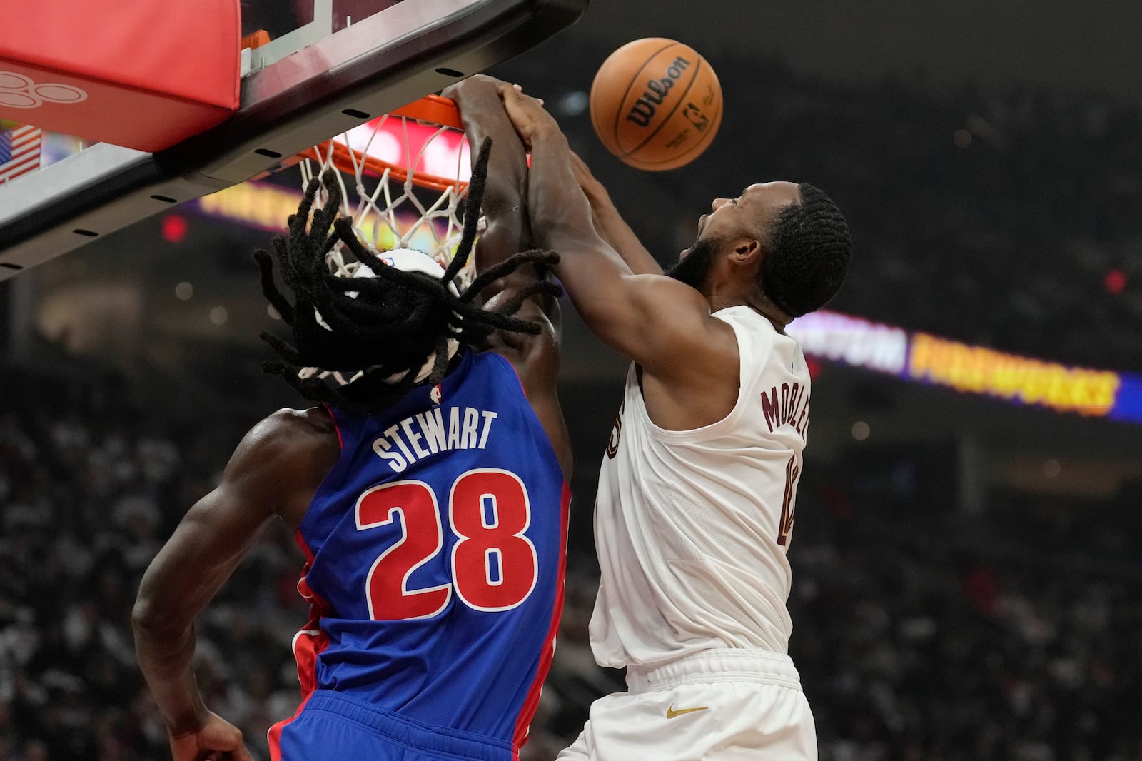 Detroit Pistons center Isaiah Stewart (28) blocks an attempted dunk by Cleveland Cavaliers forward Evan Mobley (4) in the first half of an NBA basketball game, Friday, Oct. 25, 2024, in Cleveland. (AP Photo/Sue Ogrocki)