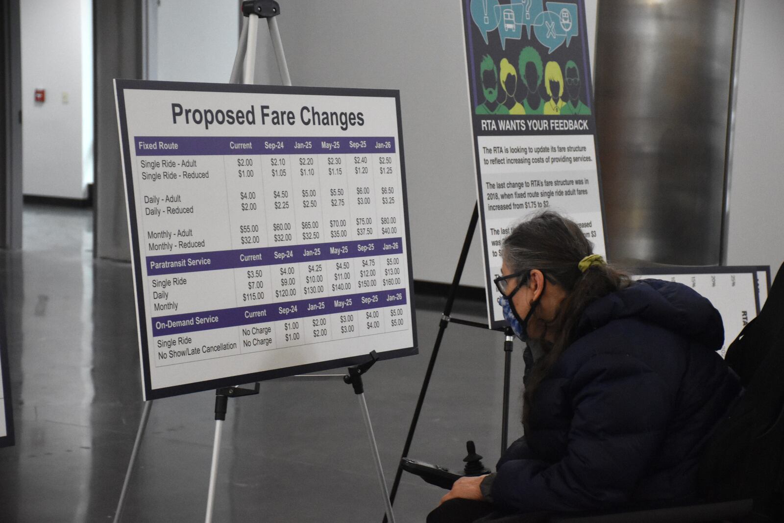 A woman studies a chart showing the Greater Dayton RTA's proposed fare hikes during a public hearing held in April 2024. CORNELIUS FROLIK / STAFF