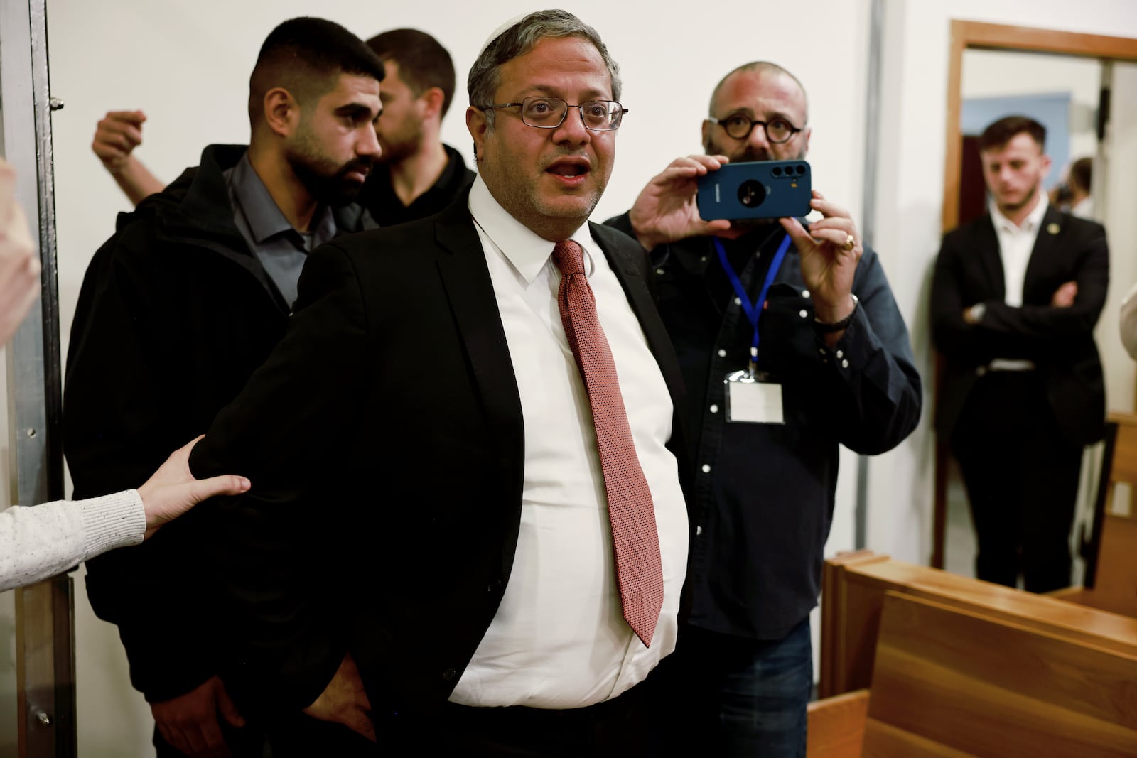 FILE - Israel's National Security Minister Itamar Ben Gvir, center, addresses the media as he enters a courtroom in Tel Aviv before the start of Prime Minister Benjamin Netanyahu's hearing, Dec. 10, 2024. (Menahem Kahana/Pool Photo via AP, File)