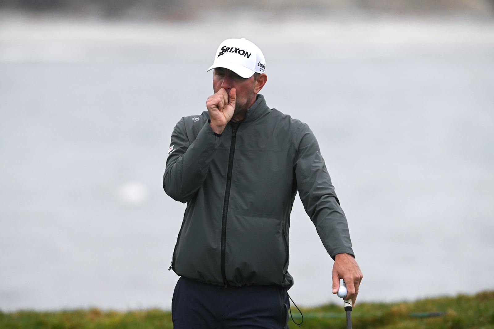 Lucas Glover warms up his hand waiting to putt on the 17th green at Pebble Beach Golf Links during the third round of the AT&T Pebble Beach Pro-Am golf tournament, Saturday, Feb. 1, 2025, in Pebble Beach, Calif. (AP Photo/Nic Coury)