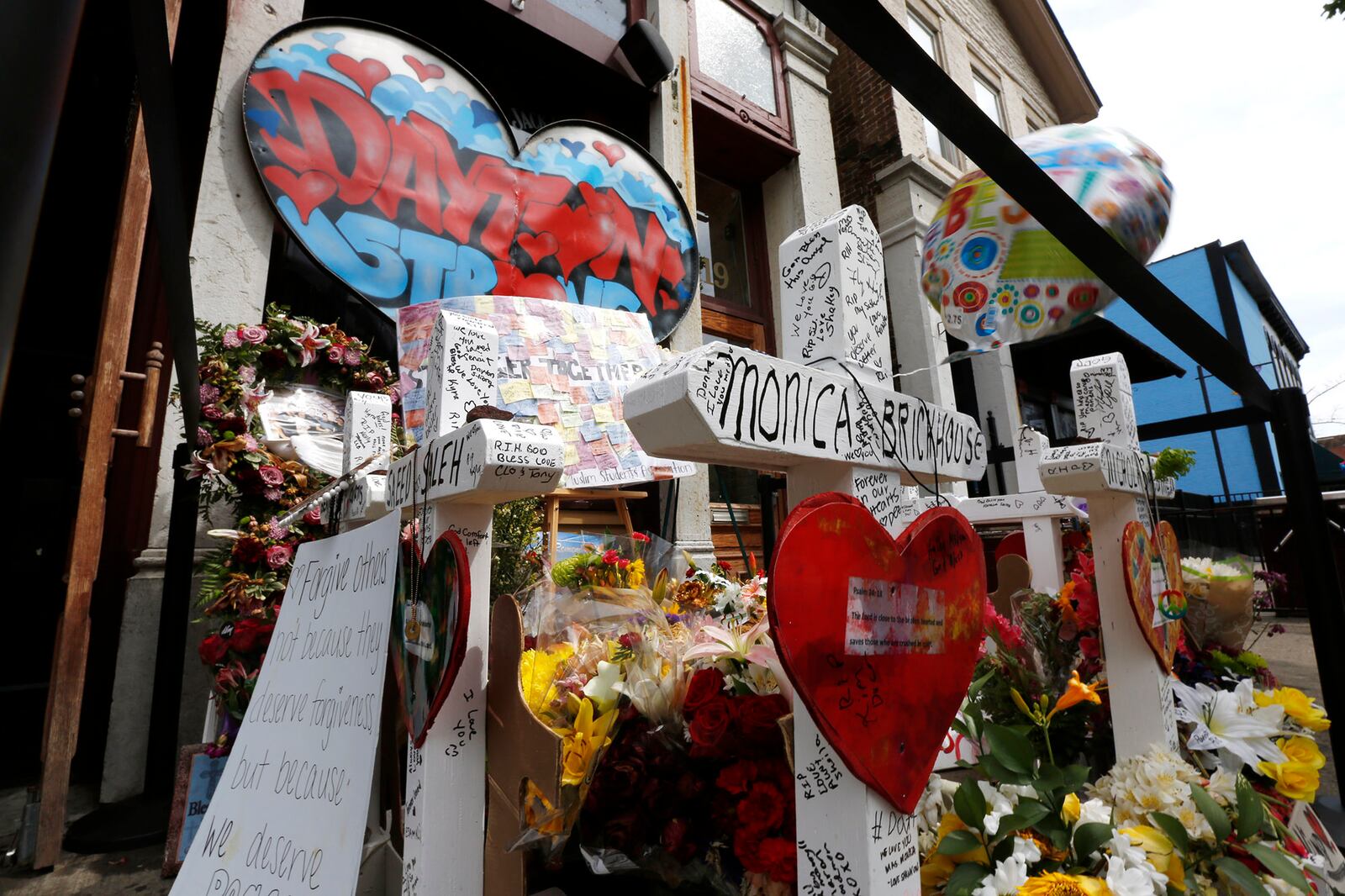 Memorials to victims of the mass shooting on August 4.   TY GREENLEES / STAFF