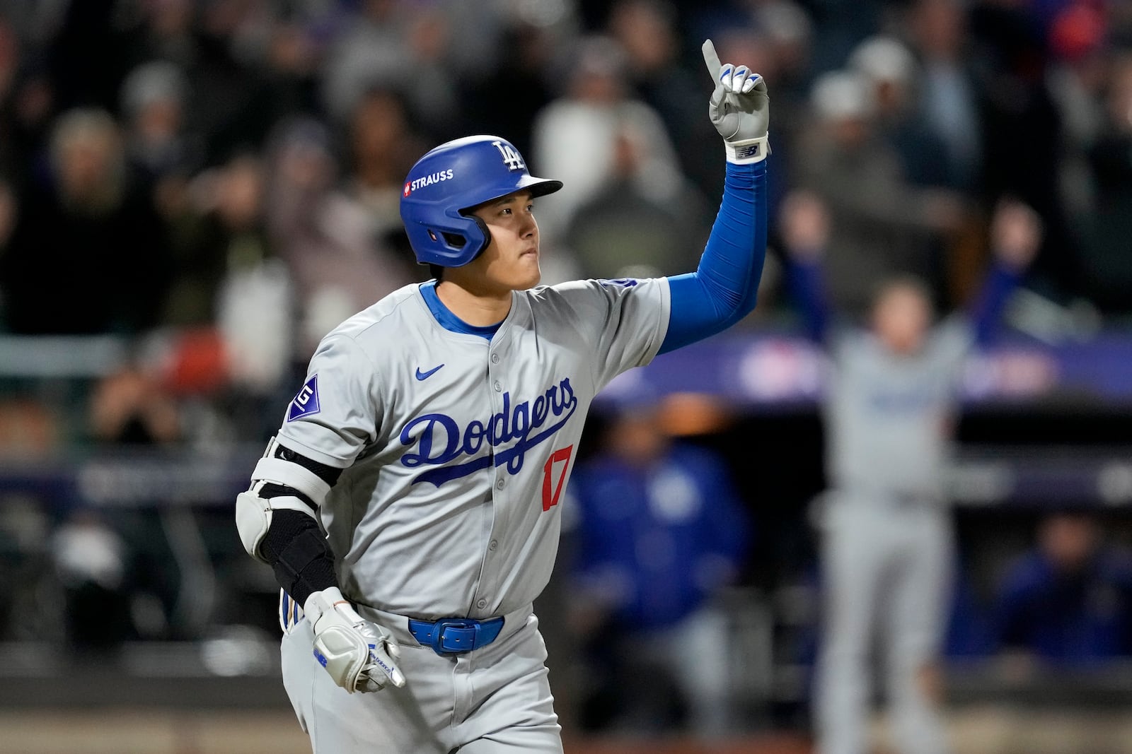 Los Angeles Dodgers' Shohei Ohtani celebrates his three-run home run against the New York Mets during the eighth inning in Game 3 of a baseball NL Championship Series, Wednesday, Oct. 16, 2024, in New York. (AP Photo/Ashley Landis)