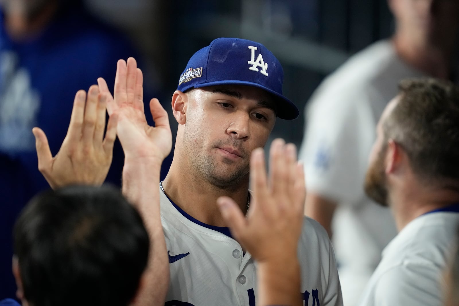 Los Angeles Dodgers pitcher Jack Flaherty is high-fived in the dugout in the seventh inning in Game 1 of a baseball NL Championship Series against the New York Mets, Sunday, Oct. 13, 2024, in Los Angeles. (AP Photo/Ashley Landis)