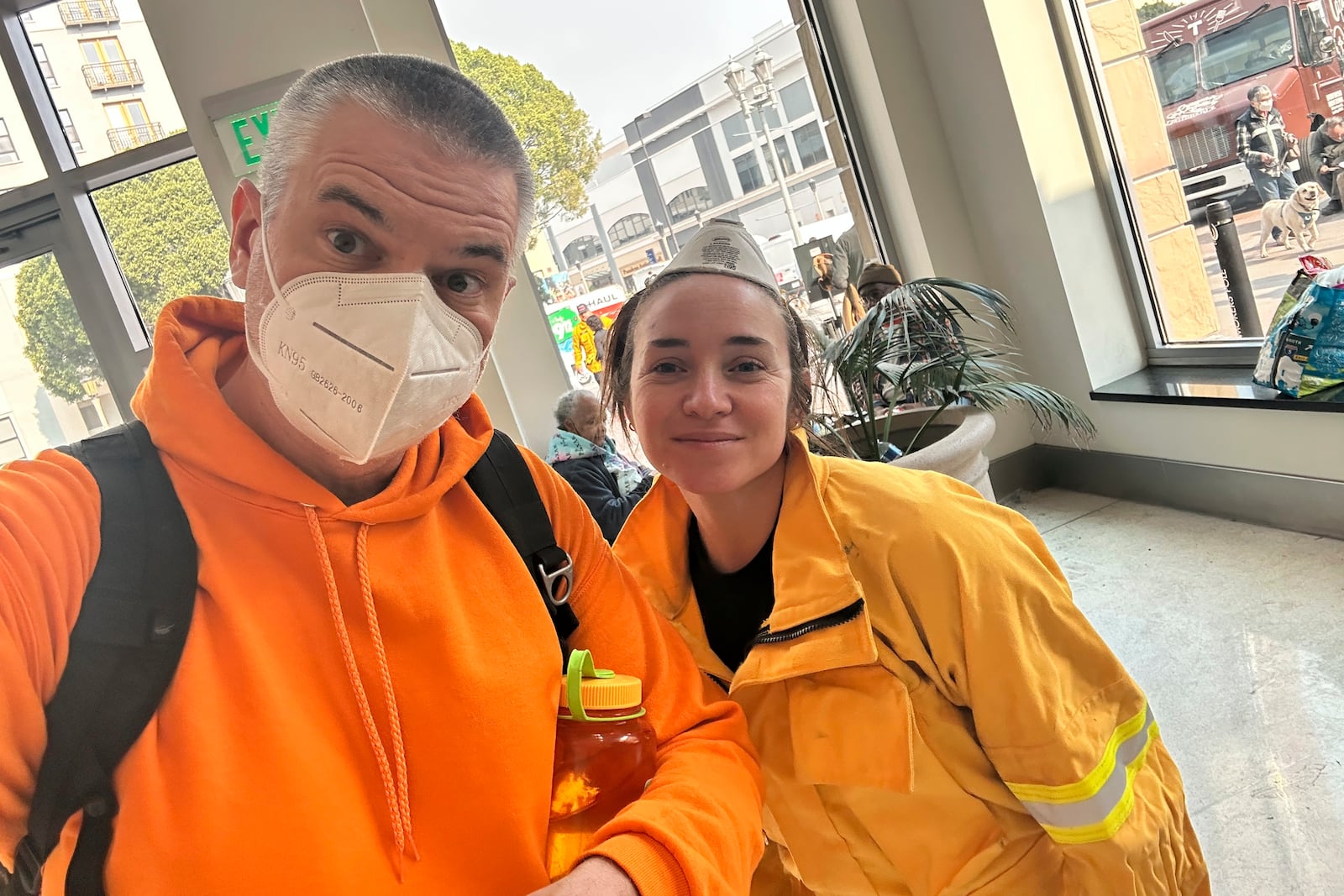 Ryan Pearson, a Los Angeles-based entertainment video editor for The Associated Press, and his colleague Krysta Fauria take a selfie at an evacuation center at the Pasadena Convention Center in Pasadena, Calif., as they interview evacuees Wednesday, Jan. 8, 2025. (AP Photo/Ryan Pearson)