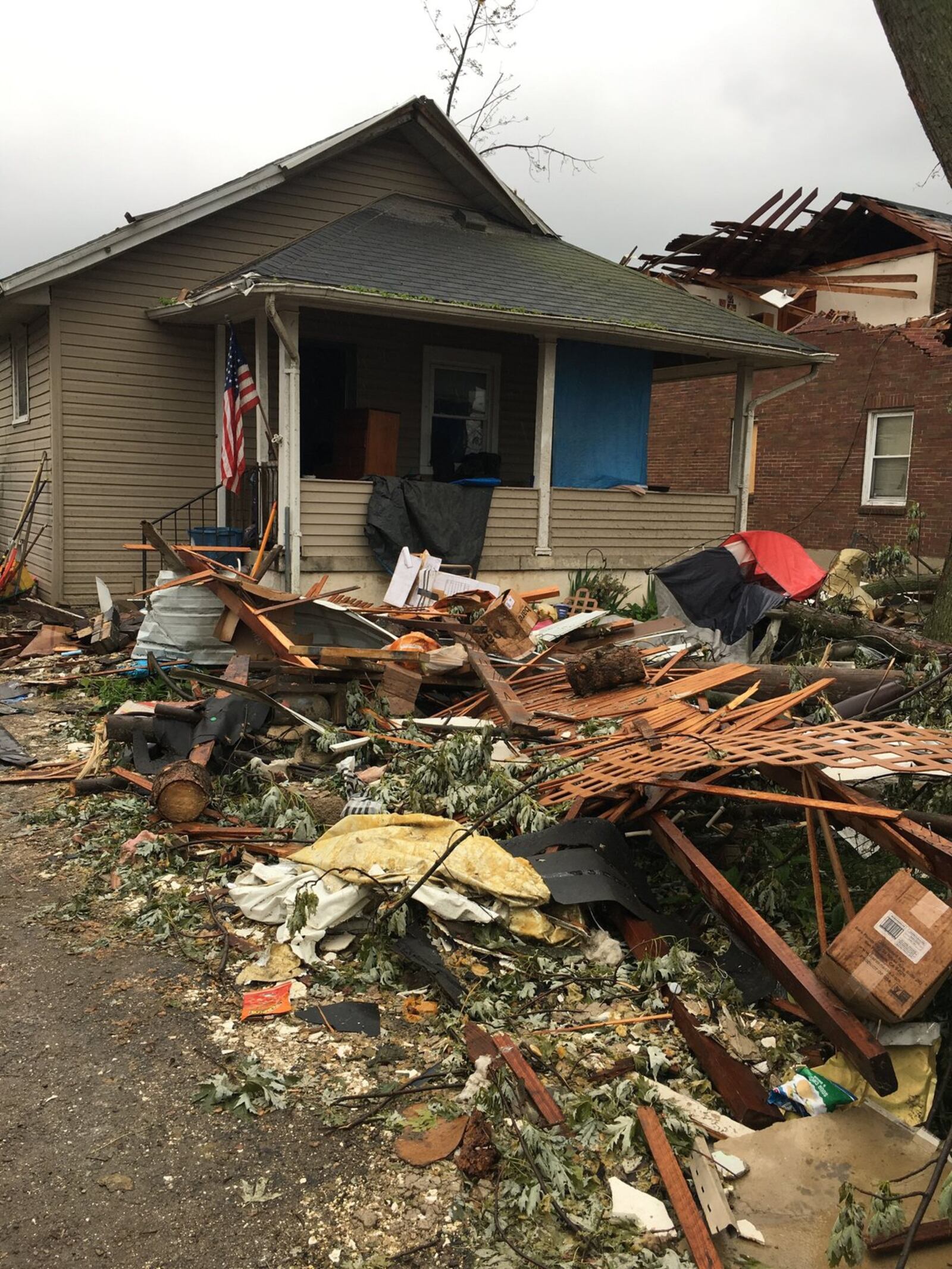 Eric Stafford salvages belongings from side by side rental houses on Troy Street in Old North Dayton, trying to save items from his home and his mother’s. “I do know there is only one way back up from here and that’s up,” he said.