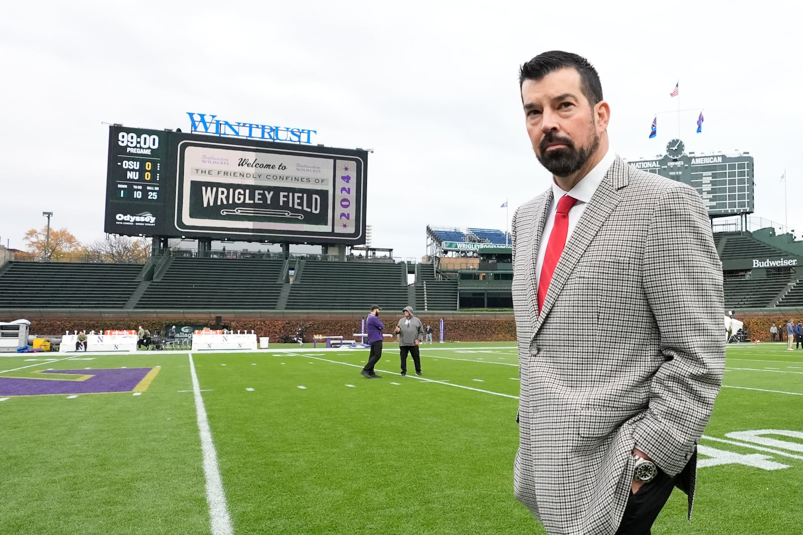 Ohio State head coach Ryan Day walks across Wrigley Field as his team arrives for an NCAA college football game against Northwestern, at the historic home of the Chicago Cubs on Saturday, Nov. 16, 2024, in Chicago. (AP Photo/Charles Rex Arbogast)