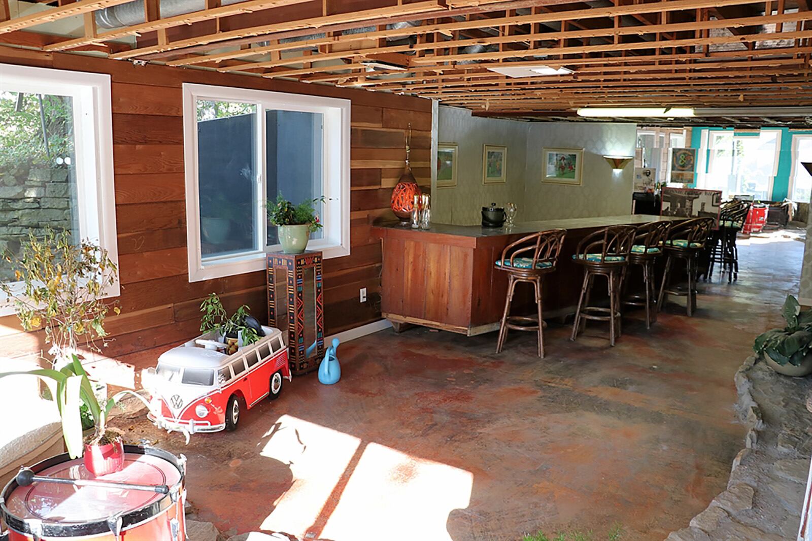 Repurposed paneling in the lower level has been used to accent walls around the windows, and there is a large peninsula bar with mirror and storage. CONTRIBUTED PHOTO BY KATHY TYLER