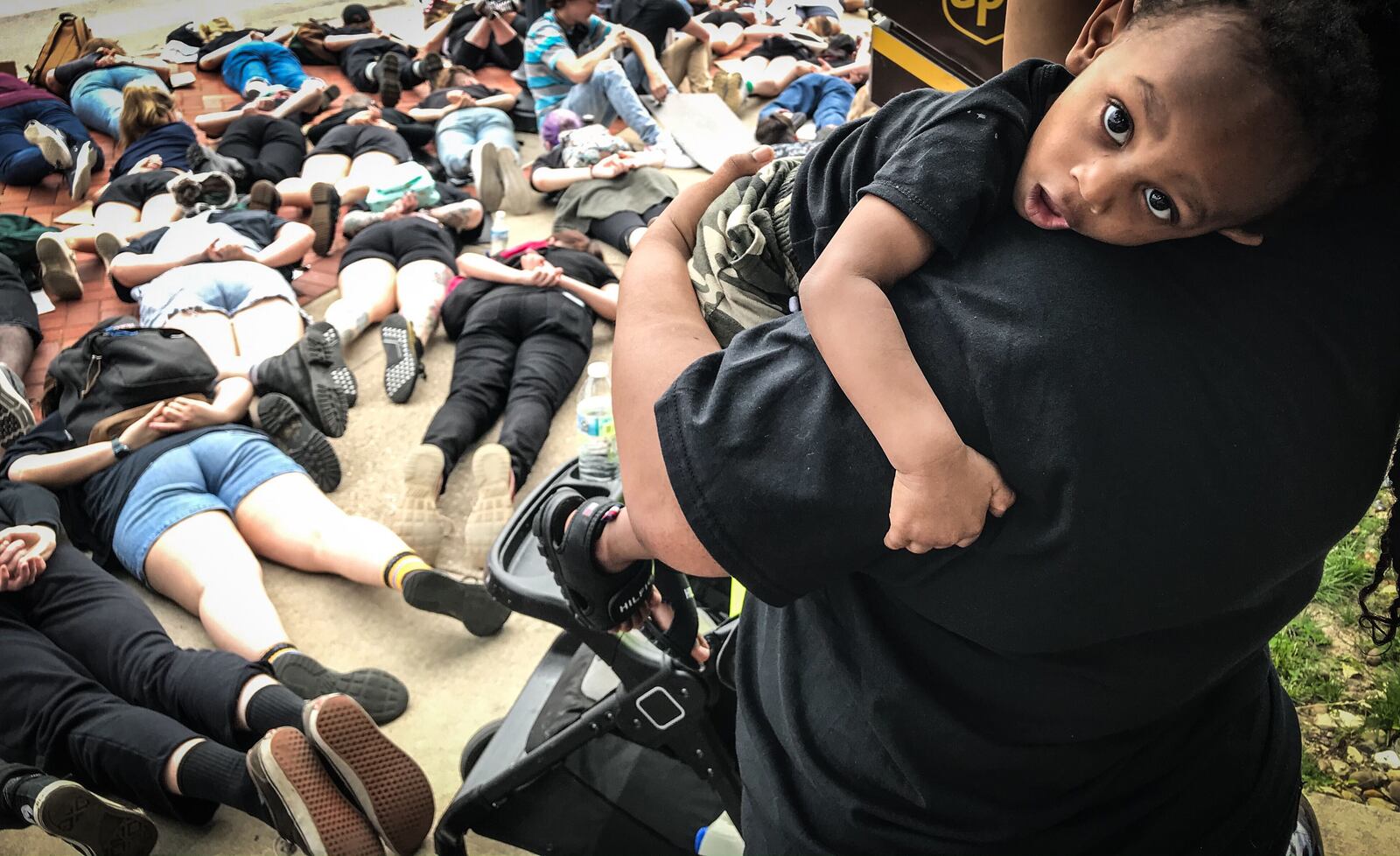 Fairborn resident Syrita Nuttall holds her one-year-old son, Jalen Highsmith, during a protest for George Floyd on Main Street Thursday afternoon. JIM NOELKER/STAFF