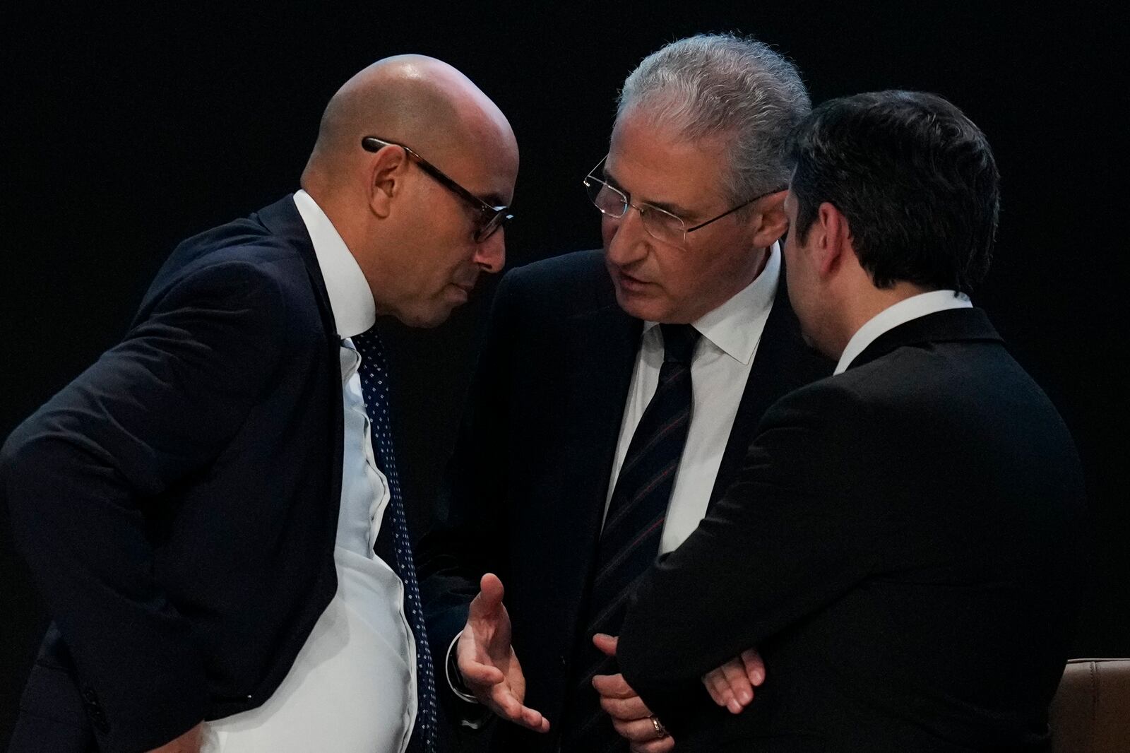 Simon Stiell, United Nations climate chief, left, Mukhtar Babayev, COP29 President, center, and Yalchin Rafiyev, Azerbaijan's COP29 lead negotiator, talk ahead of a plenary session at the COP29 U.N. Climate Summit, Sunday, Nov. 24, 2024, in Baku, Azerbaijan. (AP Photo/Rafiq Maqbool)