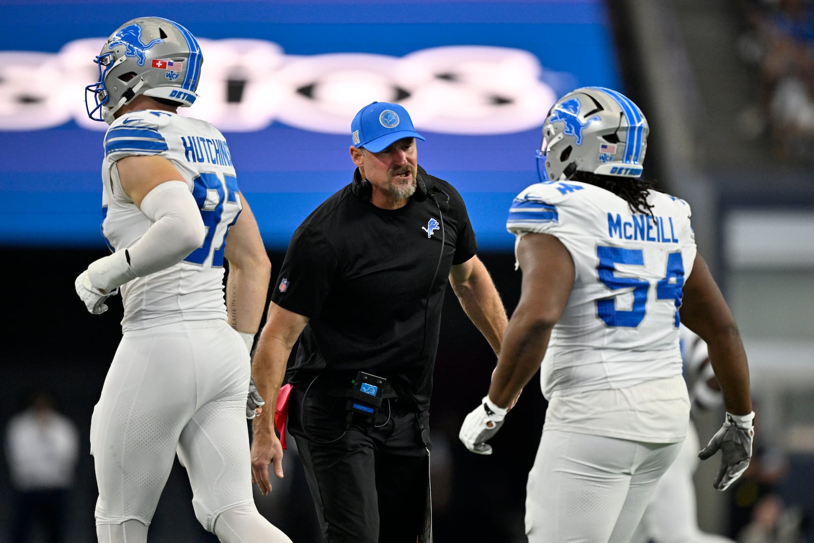 Detroit Lions head coach Dan Campbell, center, celebrates with Aidan Hutchinson (97) and Alim McNeill, right, after McNeill sacked Dallas Cowboys' Dak Prescott (4) in the first half of an NFL football game in Arlington, Texas, Sunday, Oct. 13, 2024. (AP Photo/Jerome Miron)