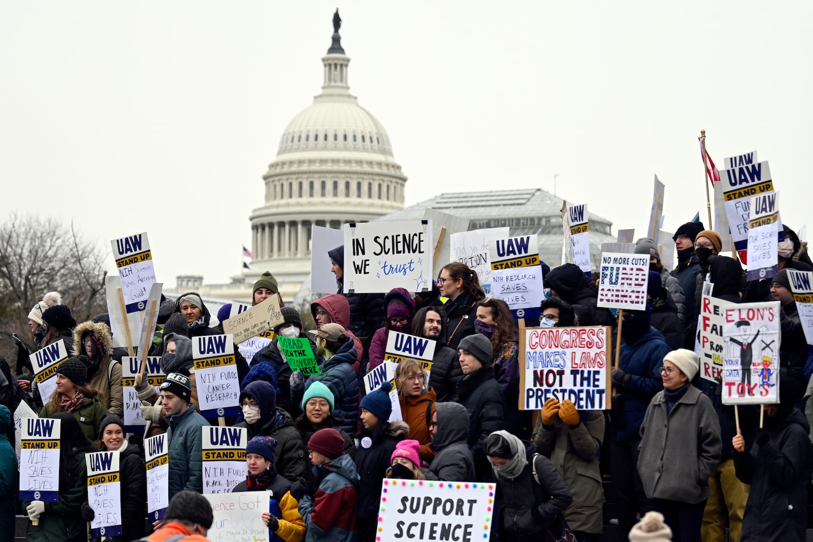 Medical researchers from universities and the National Institutes of Health rally near the Health and Human Services headquarters to protest federal budget cuts Wednesday, Feb. 19, 2025, in Washington. (AP Photo/John McDonnell)