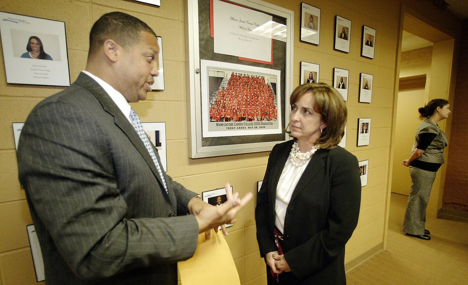 State Rep. Clayton Luckie, D-Dayton, talks with Darlene Waite, president of Miami-Jacobs Career College at the Dayton school on Friday, April 9. The two spoke after Luckie was joined by seven students who are suing the school, as well as other concerned former and current students, at a news conference. The lawsuit alleges the college told the students that a surgical technologist program was accredited when it was not.