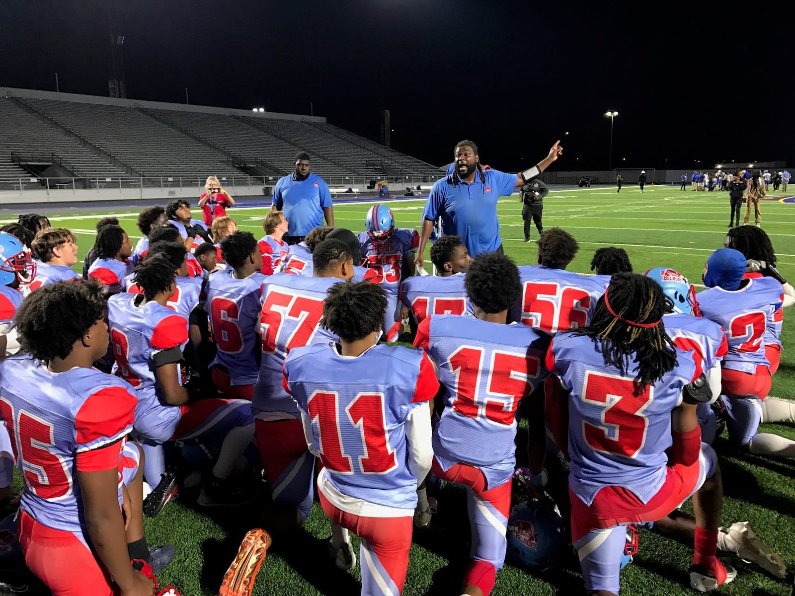 Belmont head coach Maurice Vaughn talks to his team after its first win of the season, a 20-6 victory over Ponitz in the Bison’s Homecoming Game at Welcome Stadium. Tom Archdeacon/CONTRIBUTED