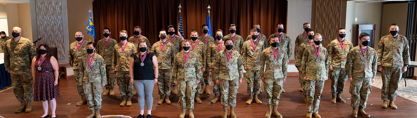 Airman Leadership School Class 21-G poses for a class photo with Col. Patrick Miller (far left), 88th Air Base Wing and installation commander, and Chief Master Sgt. Jason Shaffer (far right), 88 ABW command chief, at the end of its graduation ceremony Oct. 14 in the Wright-Patterson Club. ALS is required for staff sergeant selects and open to eligible civilians as Airmen learn more about leadership and Air Force culture. U.S. AIR FORCE PHOTO/R.J. ORIEZ