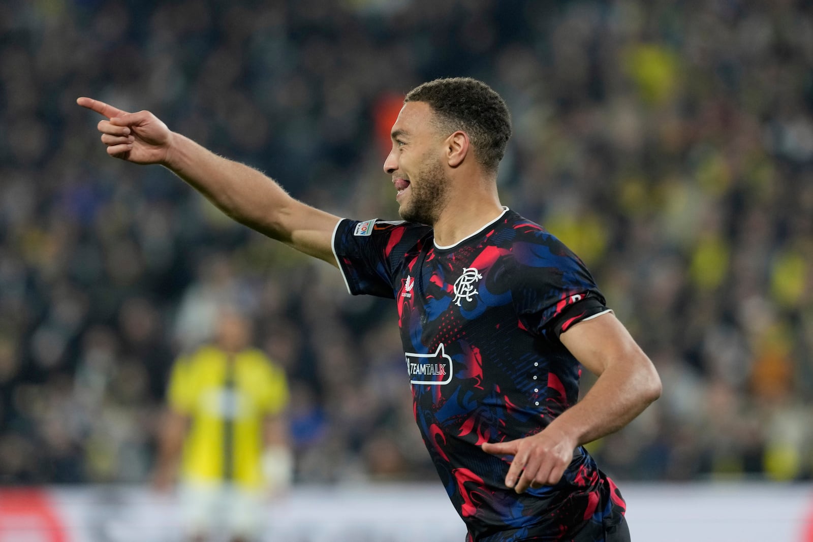 Rangers' Cyriel Dessers celebrates after scoring a goal, which was disallowed during the Europa League round of 16 first leg soccer match between Fenerbahce and Rangers at Sukru Saracoglu stadium in Istanbul, Turkey, Thursday, March 6, 2025. (AP Photo/Khalil Hamra)