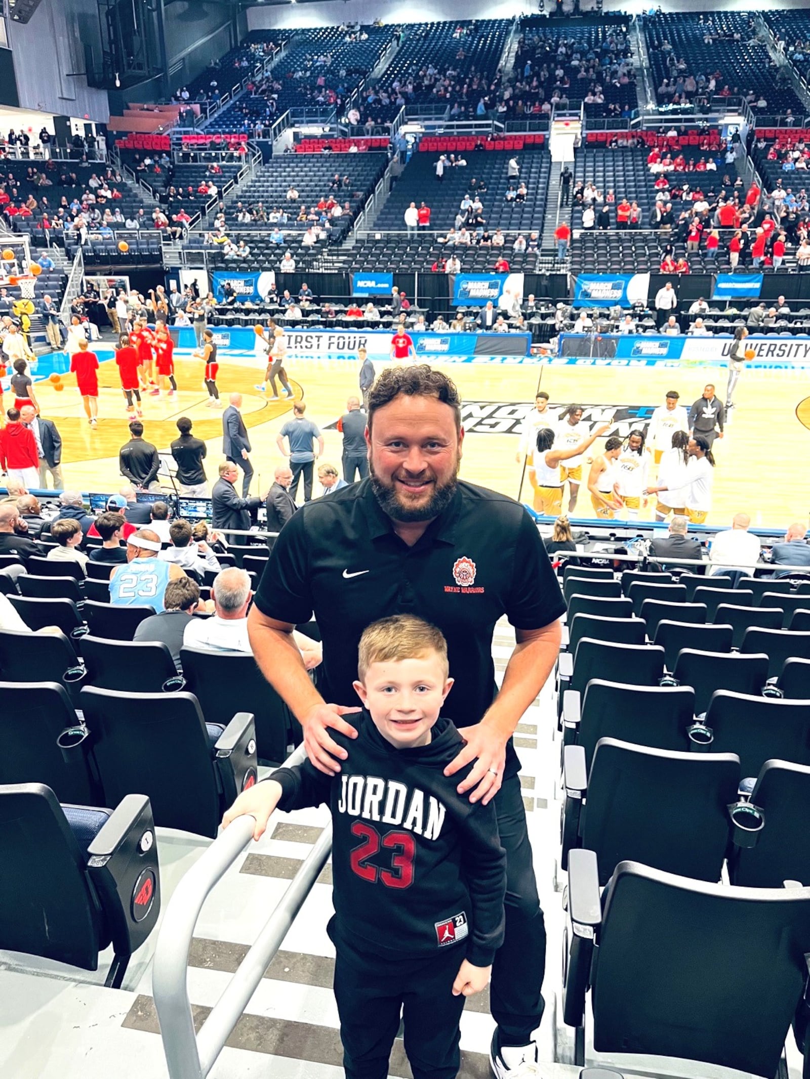 Wayne High coach Nathan “Nate”  Martindale with his 7-year-old son Xavier at Tuesday night’s First Four games. They were there to see Juan Cranford Jr., the freshman star of the Saint Francis Red Flash, who played for Martindale at Wayne High and is the hero of Xavier, who sits on the varsity bench at Wayne games and Tuesday night cheered his heart out for Cranford. CONTRIBUTED