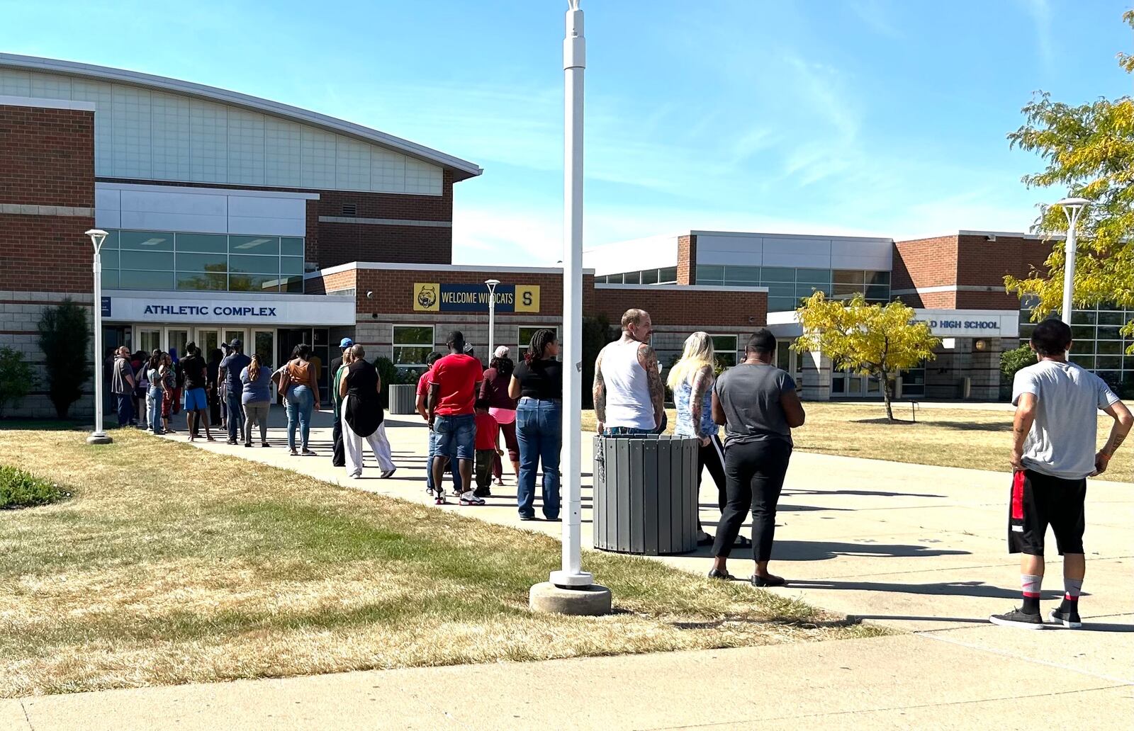 Parents wait in line outside Springfield High School to pick up their children who attend Fulton Elementary on Thursday, Sept. 12, 2024. Bomb threats were reported against multiple Springfield buildings Thursday, including City Hall, which was evacuated. JESSICA OROZCO/STAFF