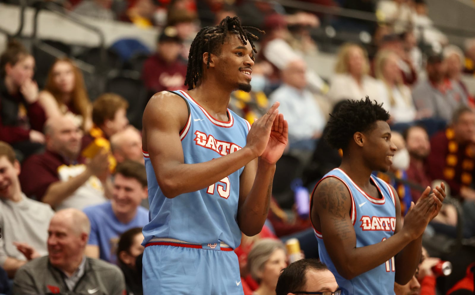 Dayton's DaRon Holmes II and Malachi Smith clap during the final minute of a victory against Loyola Chicago on Friday, Feb. 17, 2023, at Gentile Arena in Chicago, Ill. David Jablonski/Staff