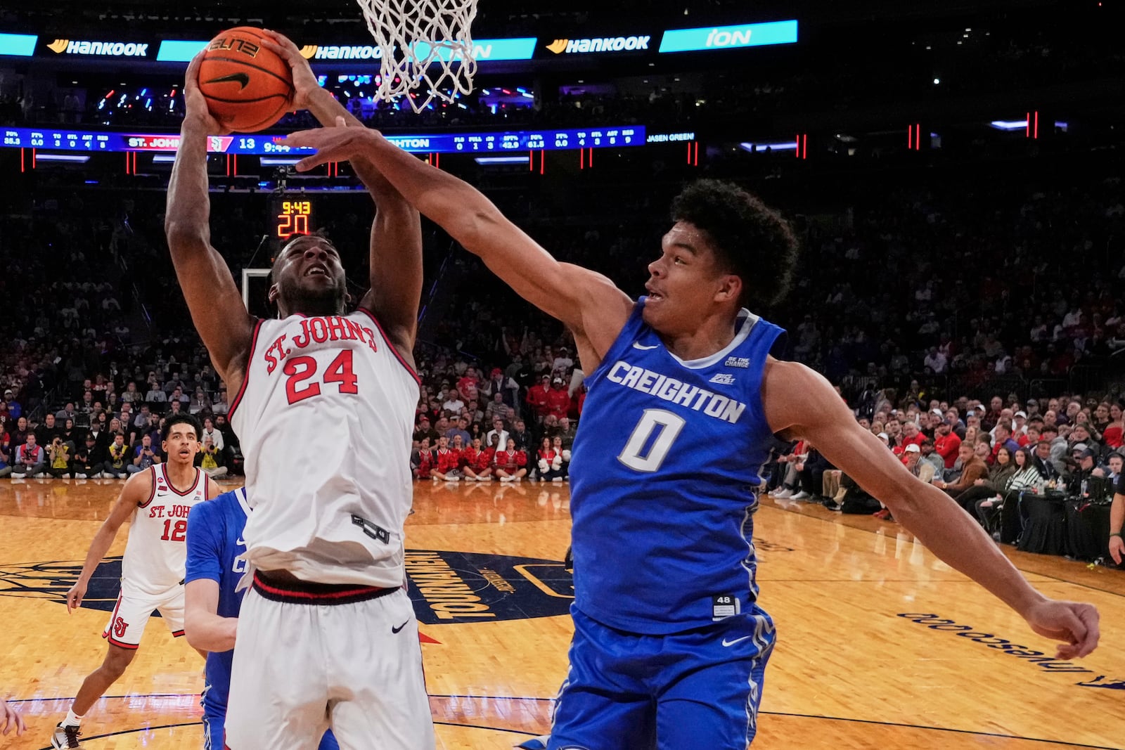 Creighton's Jasen Green (0) defends a shot by St. John's's Zuby Ejiofor (24) during the first half of an NCAA college basketball game in the championship of the Big East Conference tournament Saturday, March 15, 2025, in New York. (AP Photo/Frank Franklin II)