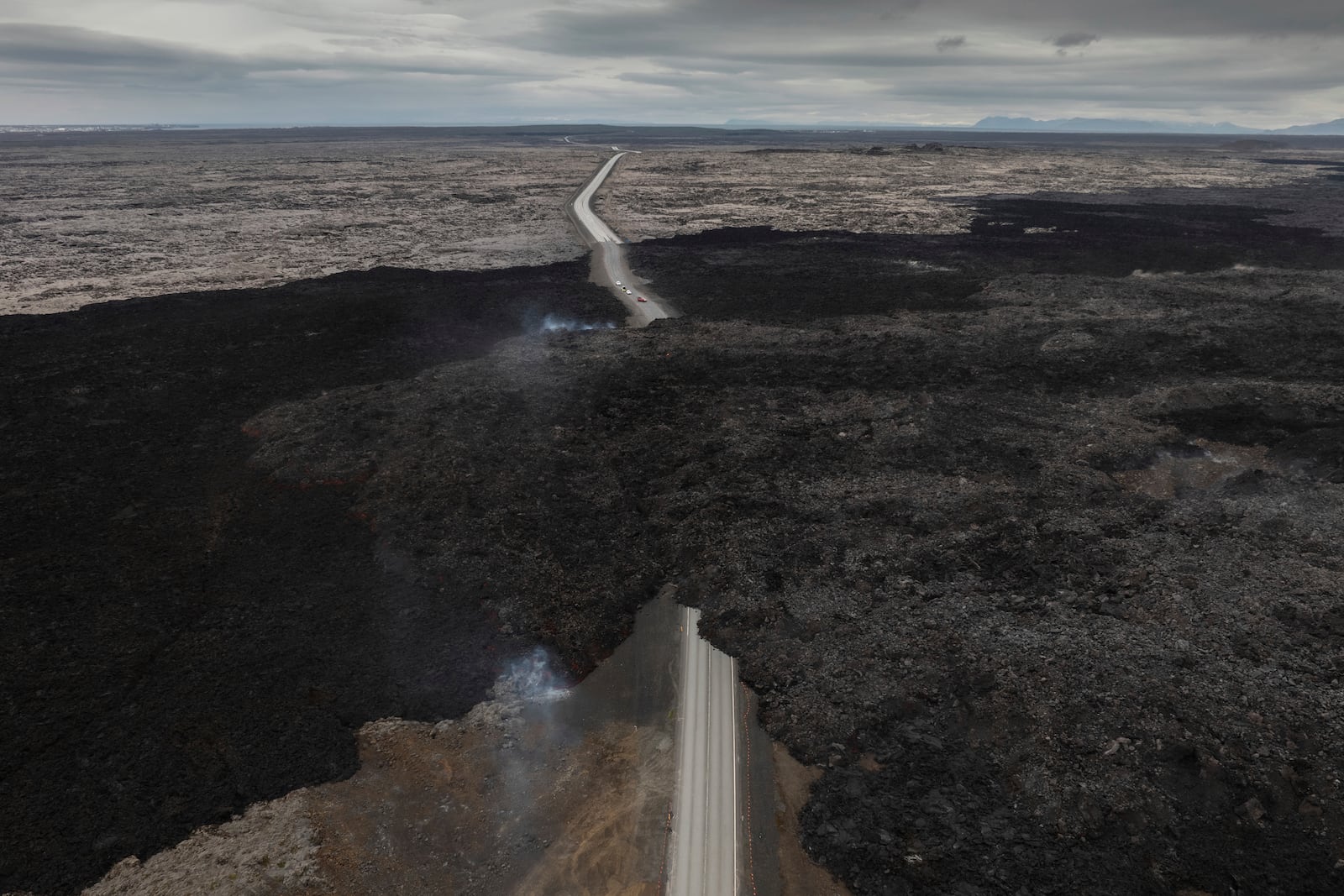 FILE - An aerial view shows lava from an active volcano engulfing the road near Grindavik, Iceland, Saturday, June 8, 2024. (AP Photo/Marco di Marco, File)