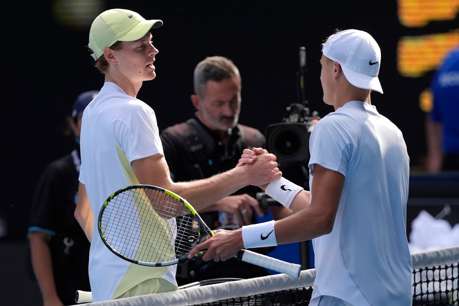 Jannik Sinner, left, of Italy is congratulated by Holger Rune of Denmark following their fourth round match at the Australian Open tennis championship in Melbourne, Australia, Monday, Jan. 20, 2025.(AP Photo/Asanka Brendon Ratnayake)