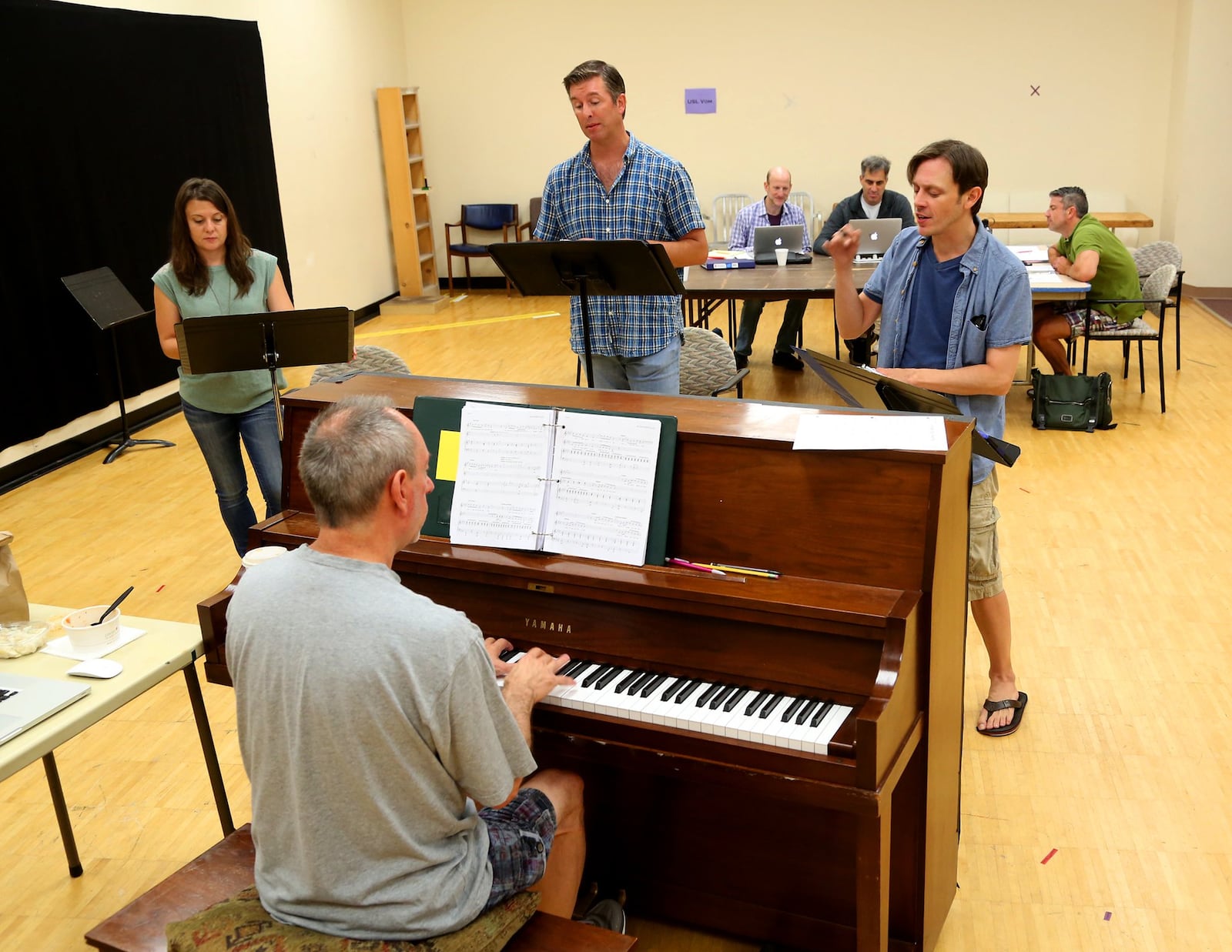 In 2015, music director Scot Woolley is shown rehearsing with cast members of “Mann … and Wife” with the Human Race Theatre Company. Actors Annie Kalahurka, Jamie Cordes and Scott Hunt (left to right) rehearse with Woolley on piano. LISA POWELL / STAFF