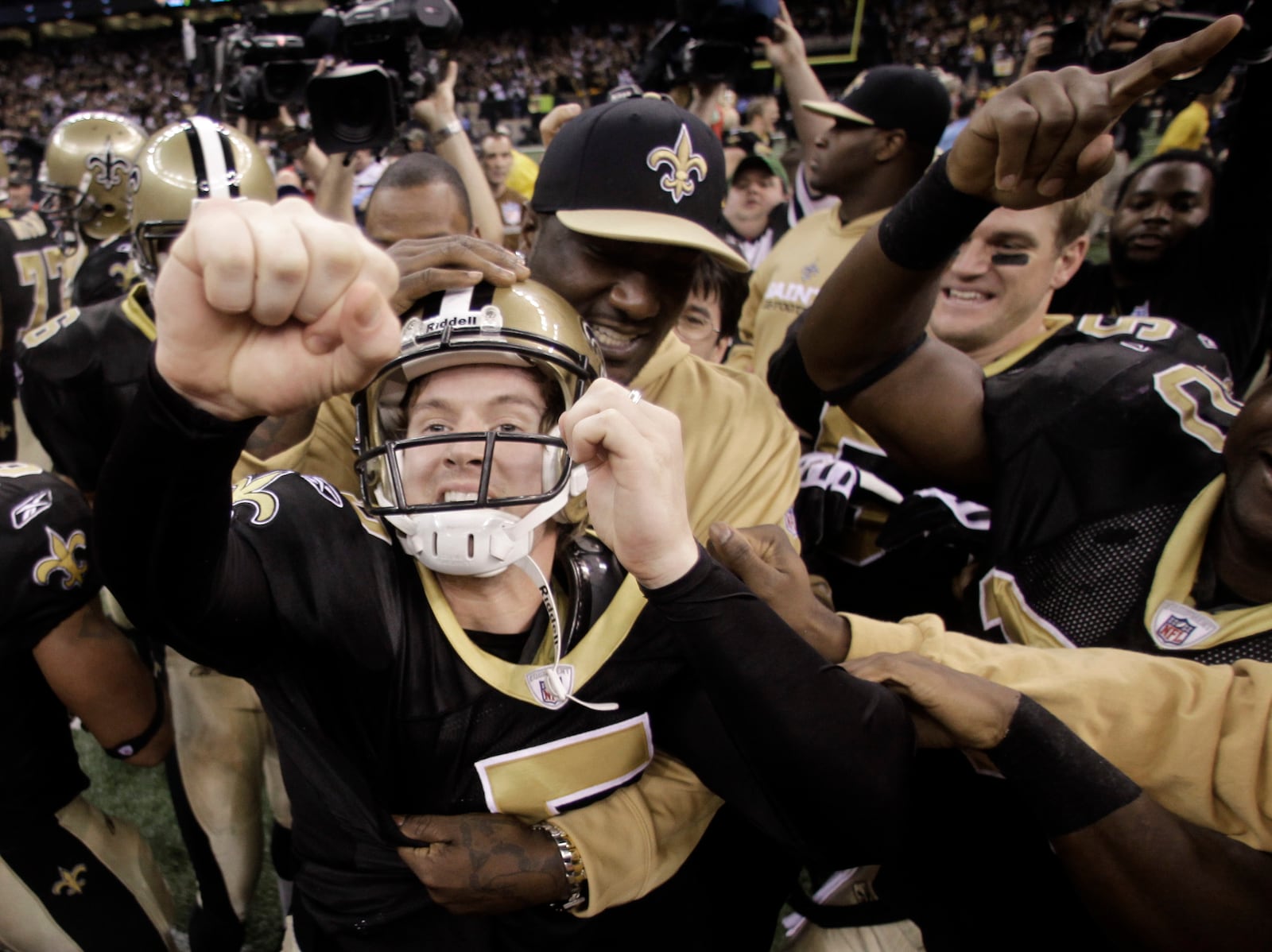 FILE - New Orleans Saints kicker Garrett Hartley celebrates with his teammates after kicking the winning field goal during overtime in the NFC Championship NFL football game in New Orleans, Jan. 24, 2010. (AP Photo/Dave Martin, File)