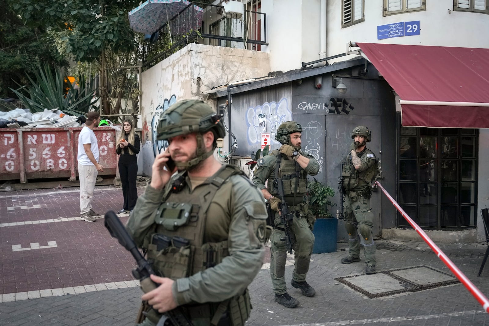 Israeli security forces secure the area of a stabbing attack in which several people were injured and the attacker was shot, in Tel Aviv, Israel, Saturday Jan. 18, 2025.(AP Photo/Oded Balilty)