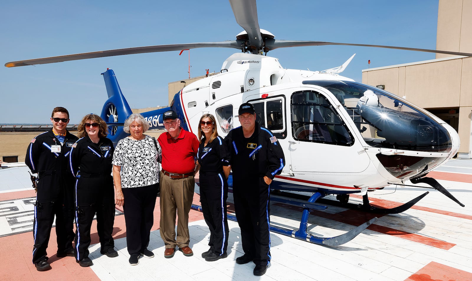 George and Sharon Pepper, center, of Huber Heights have a photo taken with CareFlight crew members, from left, Braden Wise, Roberta Ginter, Jessica Oakley and pilot Jeff Pudil. George Pepper was saved by CareFlight in 1988 and visited Friday, Aug. 23, 2024 to tour the CareFlight facilities/headquarters at Miami Valley Hospital. MARSHALL GORBY\STAFF