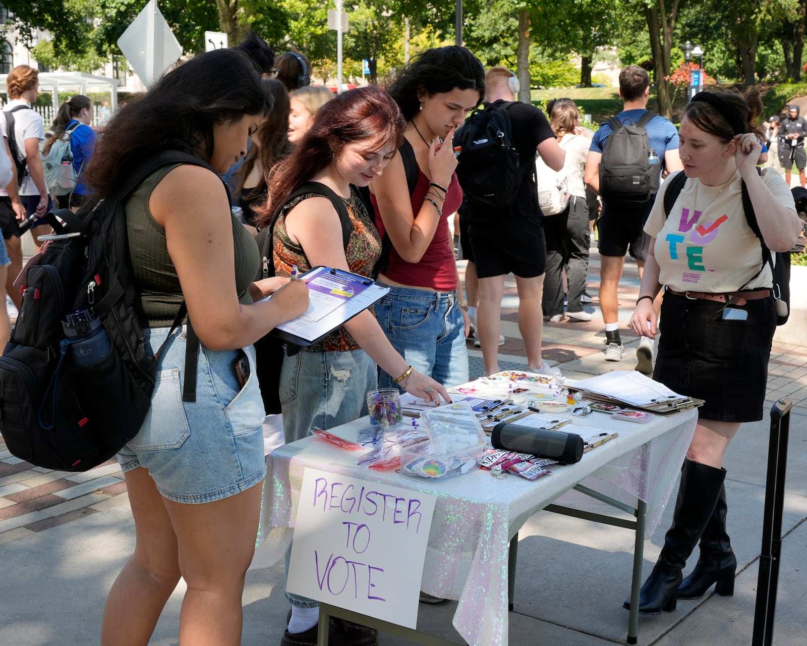 Cortney Bouse, right, explains registering to vote with University of Pittsburgh students on campus in Pittsburgh, Thursday, Sept. 12, 2024. (AP Photo/Gene J. Puskar)