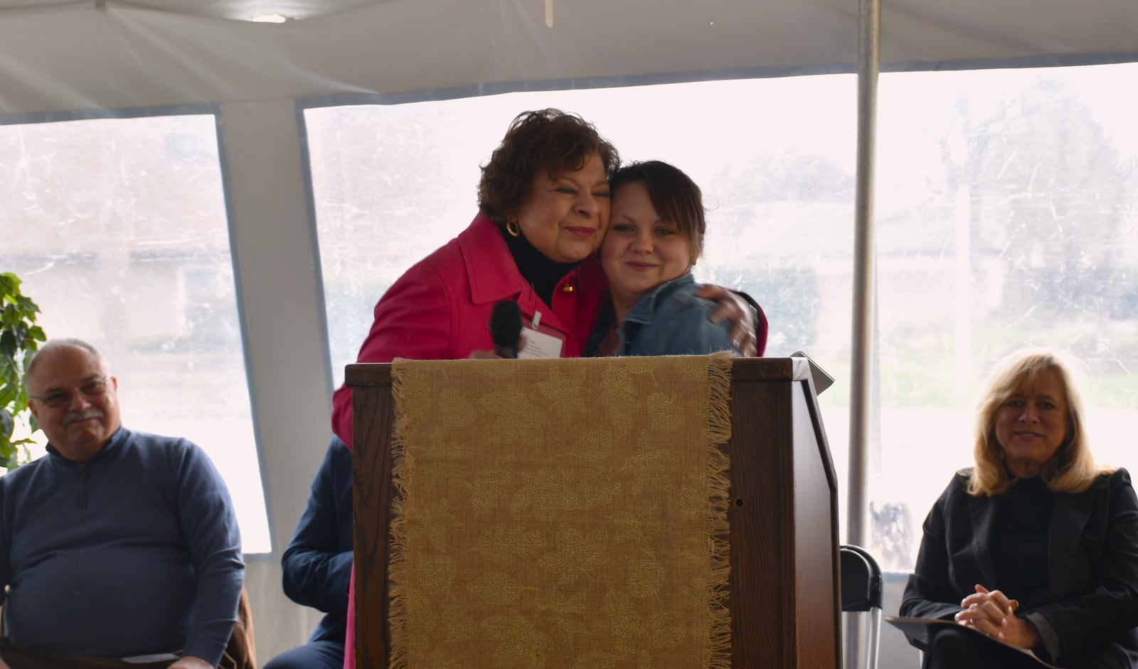 Jan Lepore-Jentleson, executive director of East End Community Services, hugs Tamarah Williams during a "wall breaking" event on April 3, 2024. The event was in celebration of East End's plans to remodel its facility on Xenia Avenue in East Dayton. CORNELIUS FROLIK / STAFF