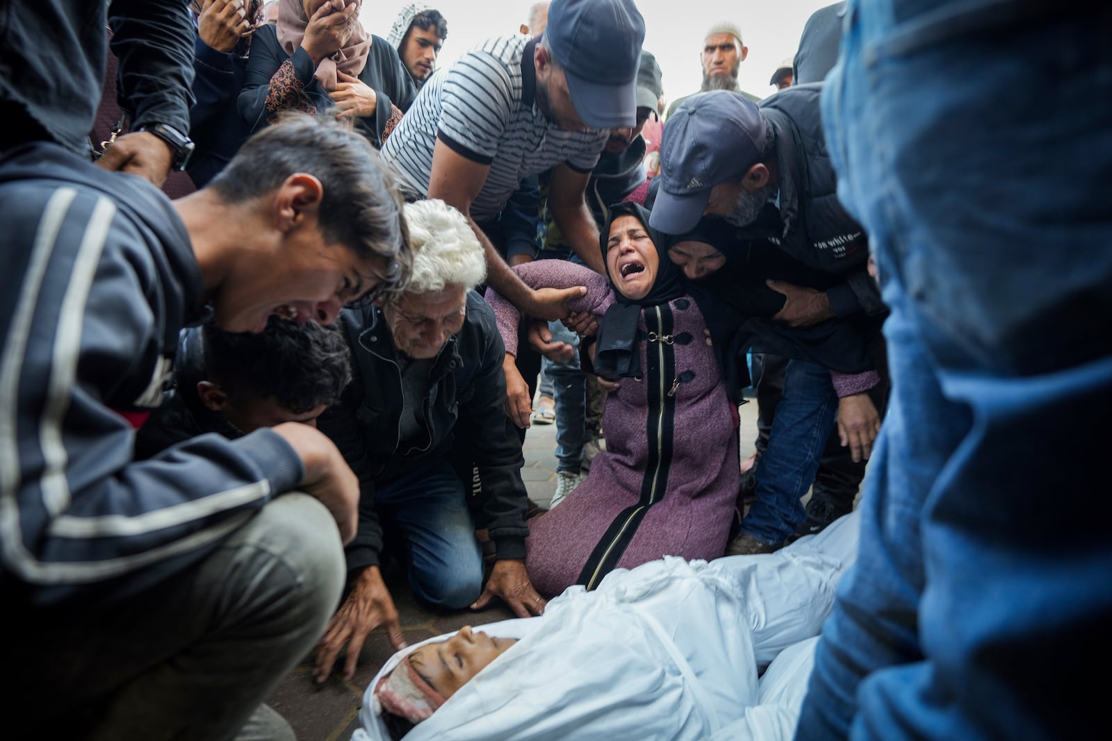 Palestinians mourn their relatives killed in the Israeli bombardment of the Gaza Strip at a hospital morgue in Deir al-Balah, Tuesday, Oct. 29, 2024. (AP Photo/Abdel Kareem Hana)