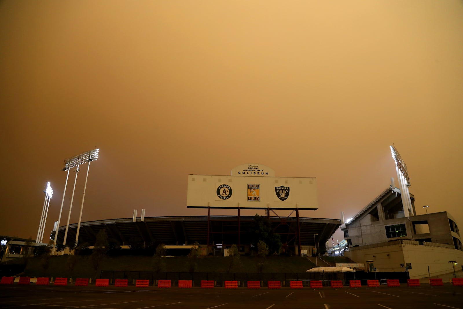 RingCentral Coliseum stands under skies darkened by wildfire smoke before the Oakland Athletics' baseball game against the Houston Astros in Oakland, Calif., Wednesday, Sept. 9, 2020. (AP Photo/Jed Jacobsohn)