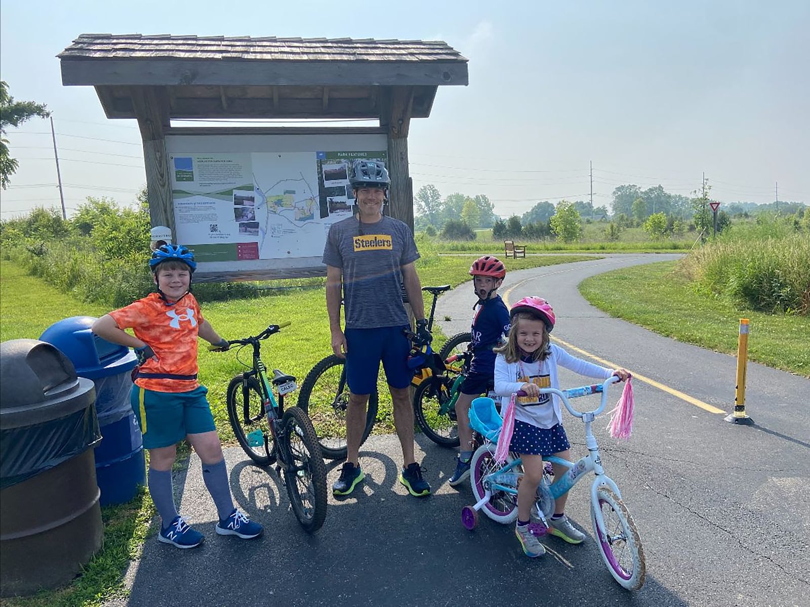 Long (second from left) and his children riding on one of the many bike paths in the Miami Valley. L-R Caleb, Long, Bennett, Virginia