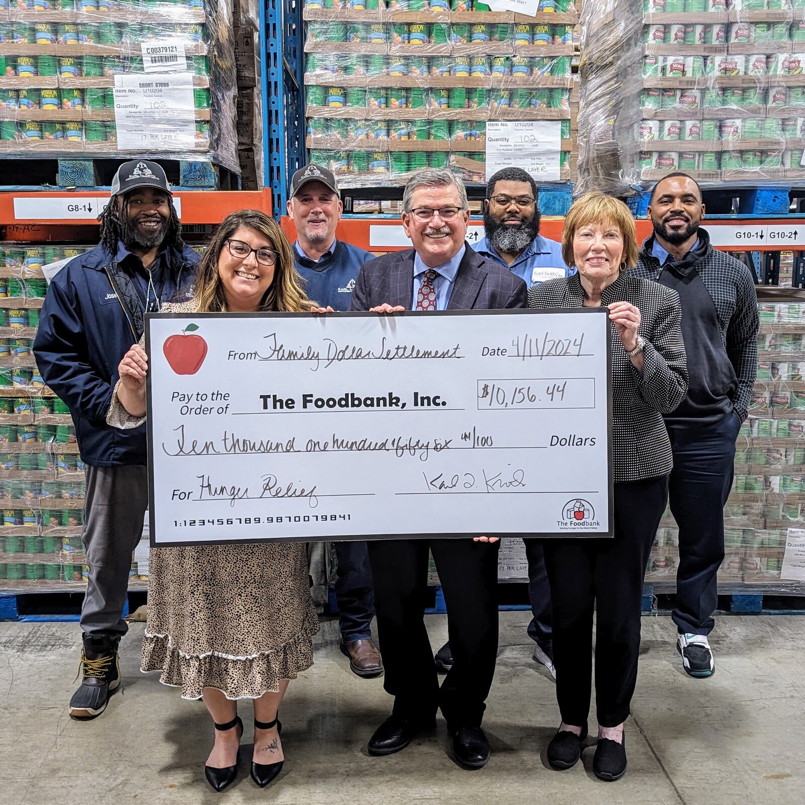 Montgomery County Auditor Karl Keith, center, presents funds from the Family Dollar Settlement to Lee Lauren Truesdale, Chief Development Officer of The Foodbank, Inc. They were joined by County Commissioner Judy Dodge, right, and four of the Auditor’s inspectors.