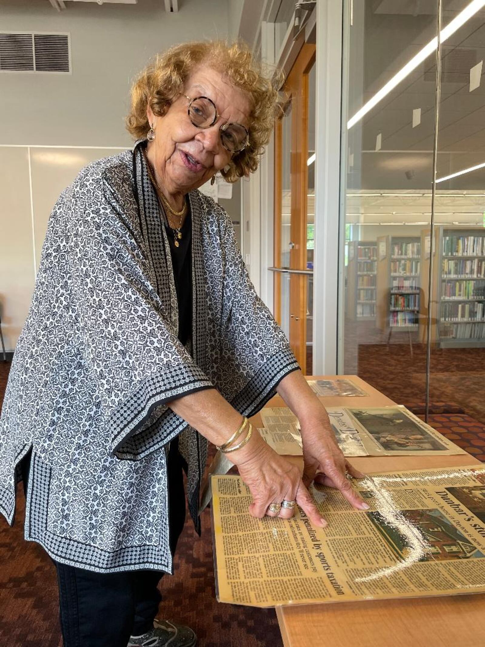 Dunbar historian and scholar LaVerne Sci examines newspaper archives concerning Dunbar.