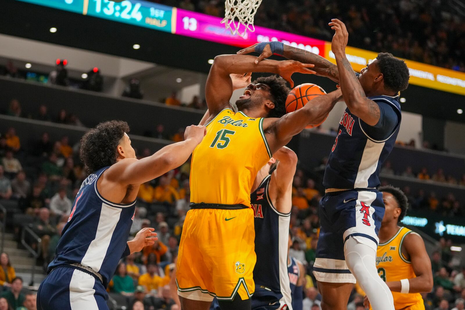 Baylor forward Norchad Omier (15) competes for a rebound against Arizona forward Trey Townsend, left, forward Henri Veesaar, center, and guard KJ Lewis during the first half of an NCAA college basketball game Monday, Feb. 17, 2025, in Waco, Texas. (AP Photo/Julio Cortez)