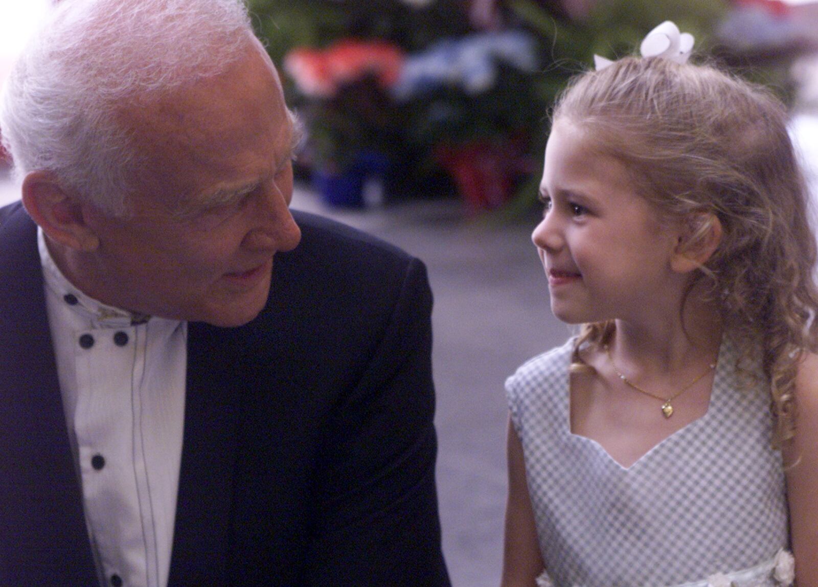 National Aviation Hall of Fame inductee Buzz Aldrin chats with four-year-old Wensley Guthrie who is from Texas and came with her family to attend the induction ceremonies.  Guthrie is the great, great niece of Laurence Craigie, who is also a Class of 2000 inductee.