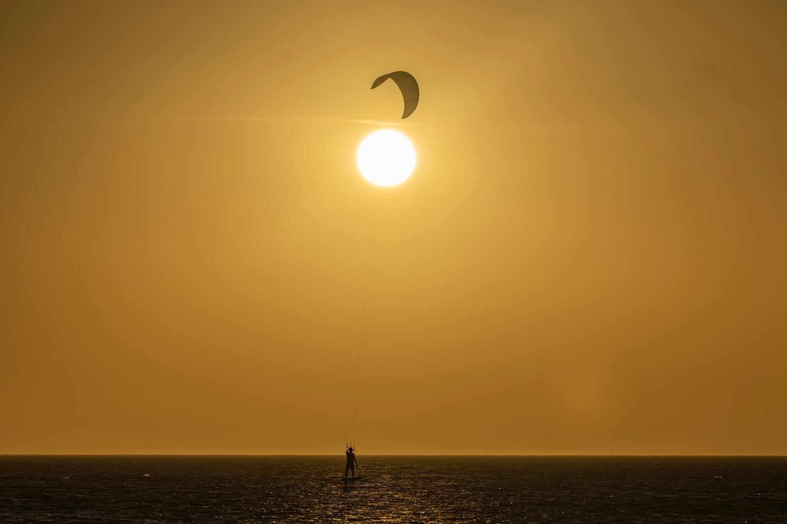 A member of the Wayuu Indigenous group kitesurfs in Cabo de la Vela, Colombia, Friday, Feb. 7, 2025. (AP Photo/Ivan Valencia)