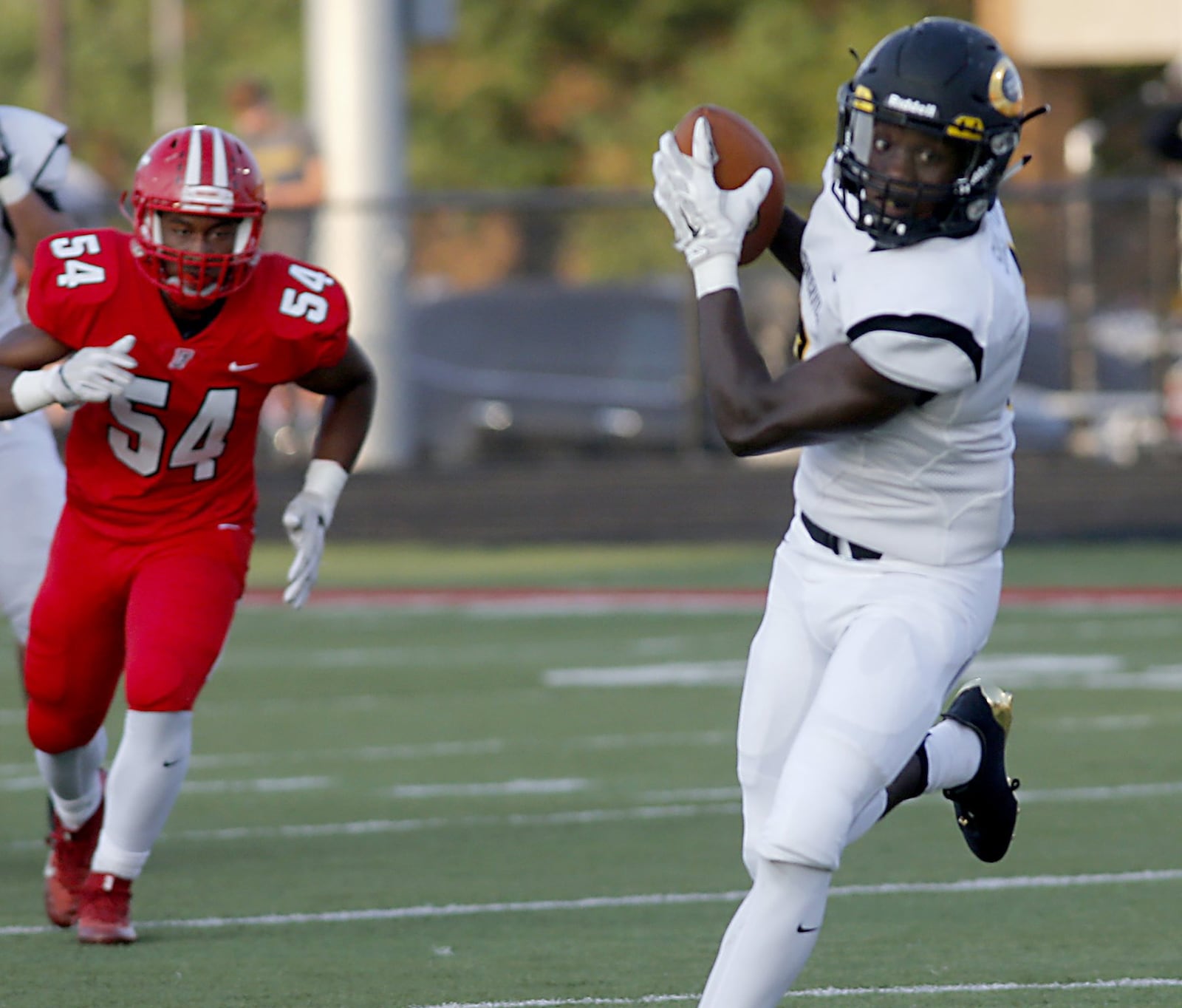 Centerville wide receiver Donovan Shelton catches a pass for a big gain as Fairfield’s Del Thomas trails the play Friday night during the visiting Elks’ 30-23 win in the Skyline Chili Crosstown Showdown at Fairfield Stadium. CONTRIBUTED PHOTO BY E.L. HUBBARD