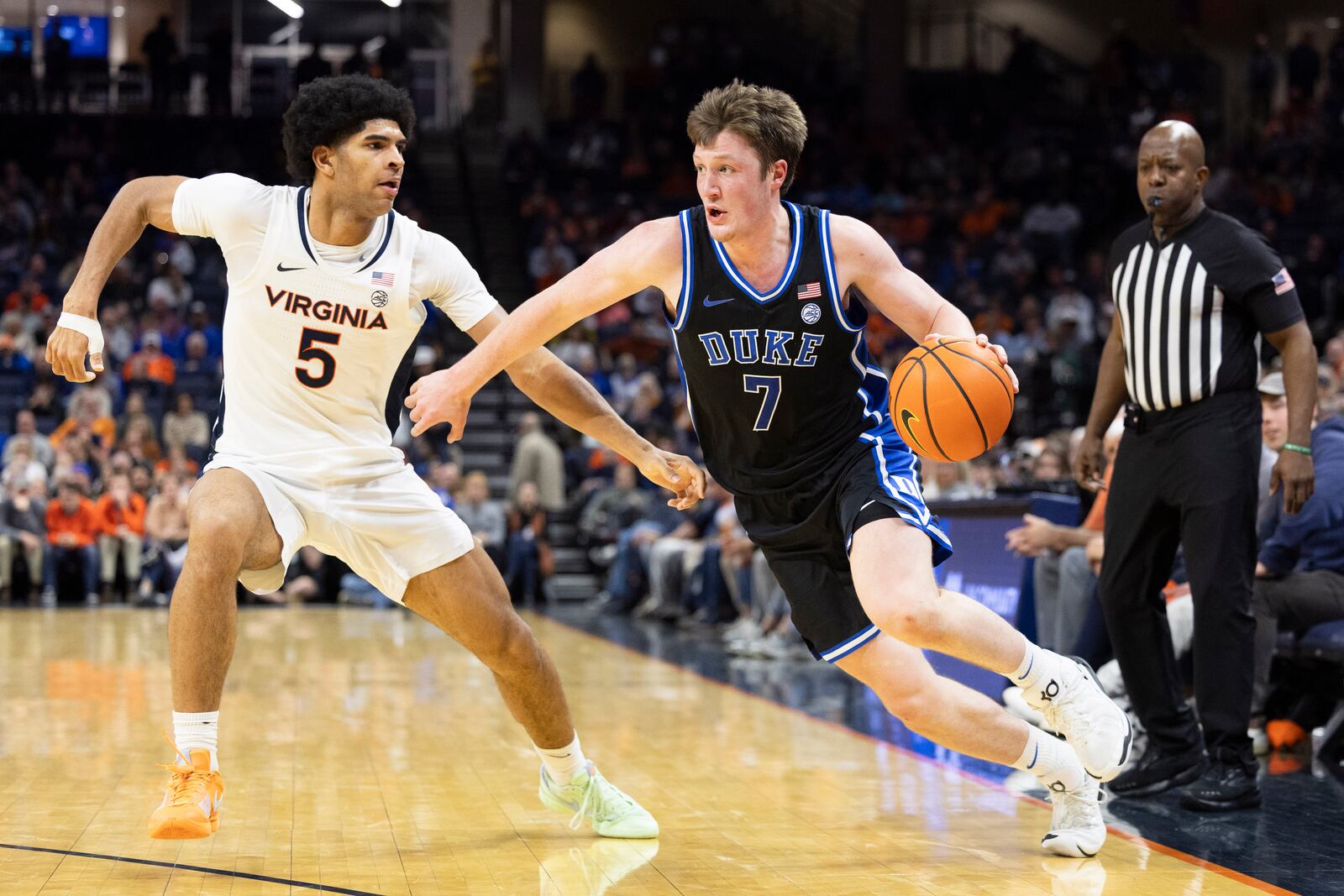 Duke guard Kon Knueppel (7) defends the ball from Virginia forward Jacob Cofie (5) during the second half of an NCAA college basketball game, Monday, Feb. 17, 2025, in Charlottesville, Va. (AP Photo/Mike Kropf)