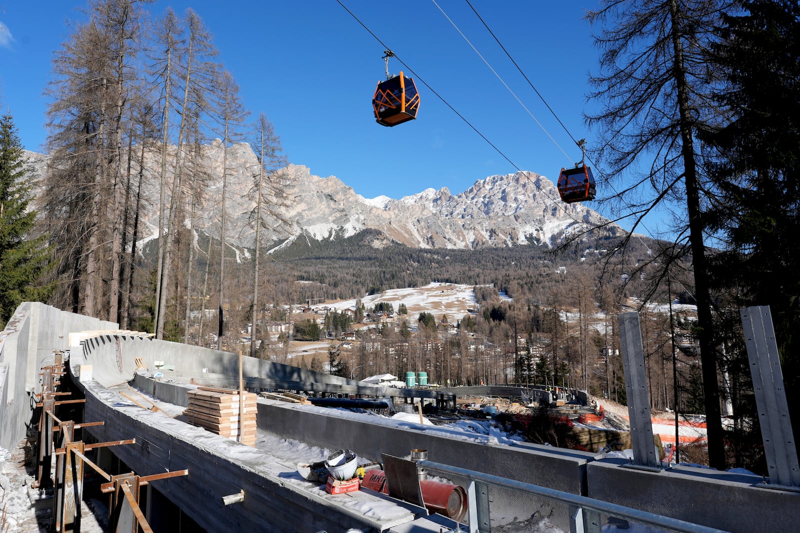 Construction work takes place at the Cortina Sliding Center, venue for the bob, luge and skeleton disciplines at the Milan Cortina 2026 Winter Olympics, in Cortina d'Ampezzo, Italy, Thursday, Jan. 16, 2025. (AP Photo/Giovanni Auletta)