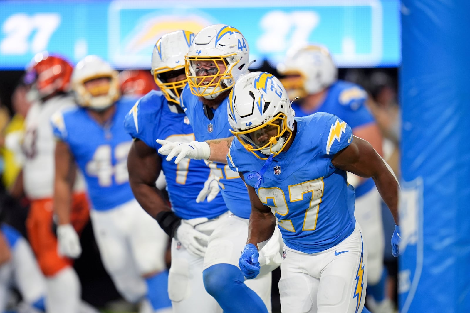 Los Angeles Chargers running back J.K. Dobbins (27) runs back to the bench after scoring a rushing touchdown during the second half of an NFL football game against the Cincinnati Bengals, Sunday, Nov. 17, 2024, in Inglewood, Calif. (AP Photo/Gregory Bull)