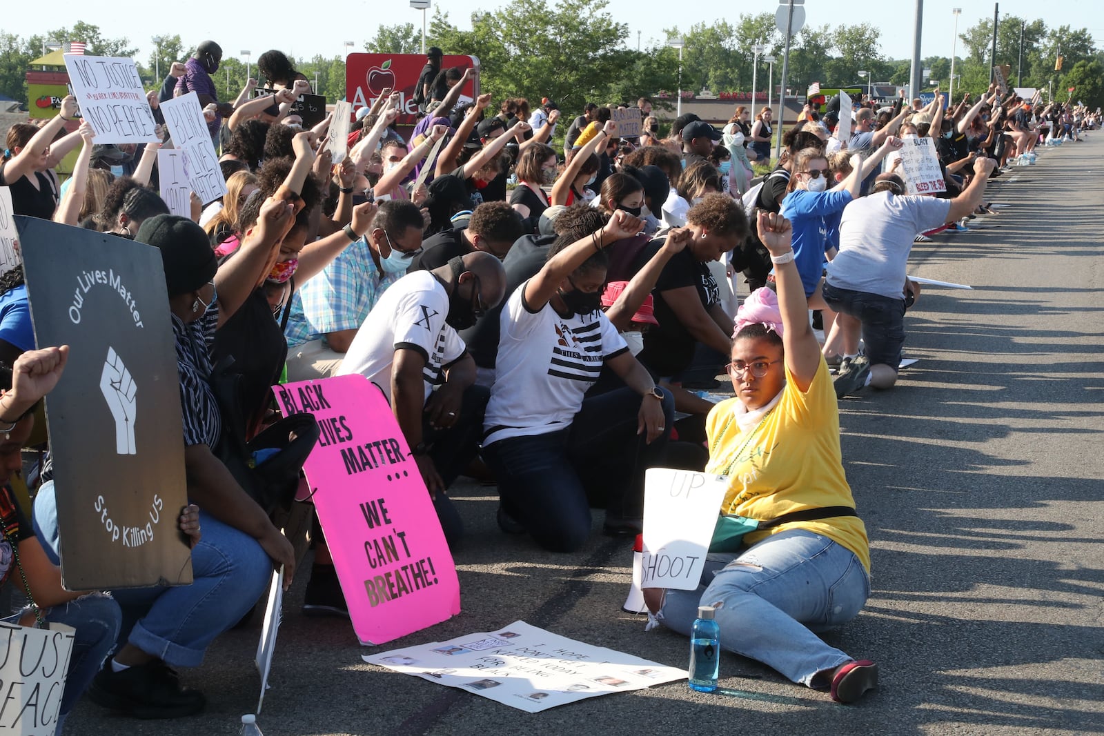 Protestors take a knee during a demonstration along Old Troy Pike in Huber Heights on Saturday, June 6, 2020. Bill Lackey/STAFF