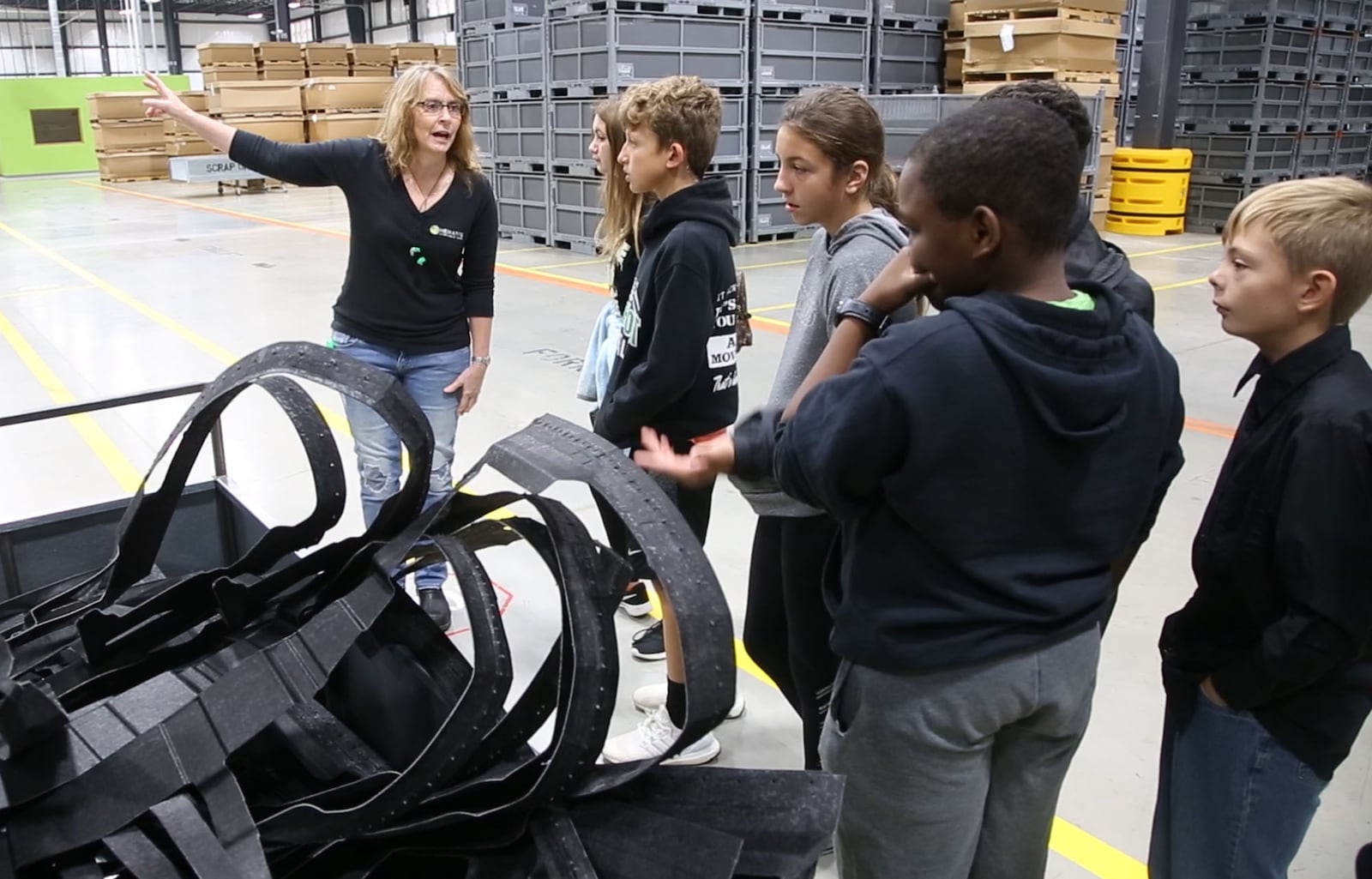 Northmont sixth grade students watch auto parts being made during a Manufacturing Day visit to the automotive parts manufacturer Hematite that recently opened in Englewood.  Hematite makes under body shields, under engine covers and plastic wheel liners for auto manufacturers.   TY GREENLEES / STAFF